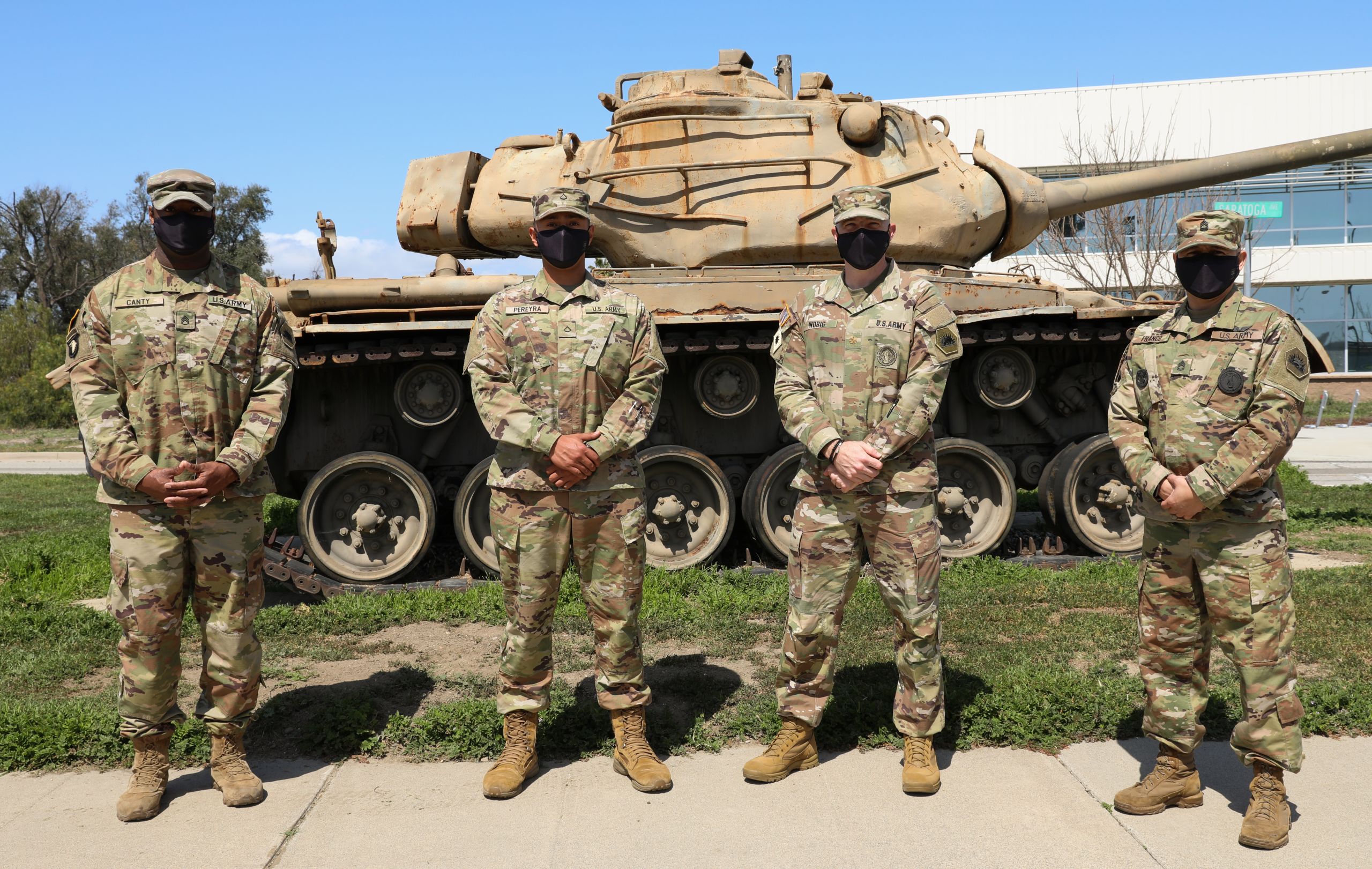 U.S. Army Pfc. Enrique Pereya stands proudly alongside leaders of the California National Guard's Recruit Sustainment Program at Joint Forces Training Base, Los Alamitos, California, March 20, 2021. Members of the RSP helped Pereya through difficult times when he was facing homelessness, but thanks to their help and support is now an automated logistical specialist with the 40th Infantry Division, pictured from left to right: Staff Sgt. Devon Canty, Pfc Enrique Pereyra, Maj. Timothy Wobig, and Sgt. 1st Class Carlos Franco. (U.S. Army National Guard photo by Spc. Simone Lara)