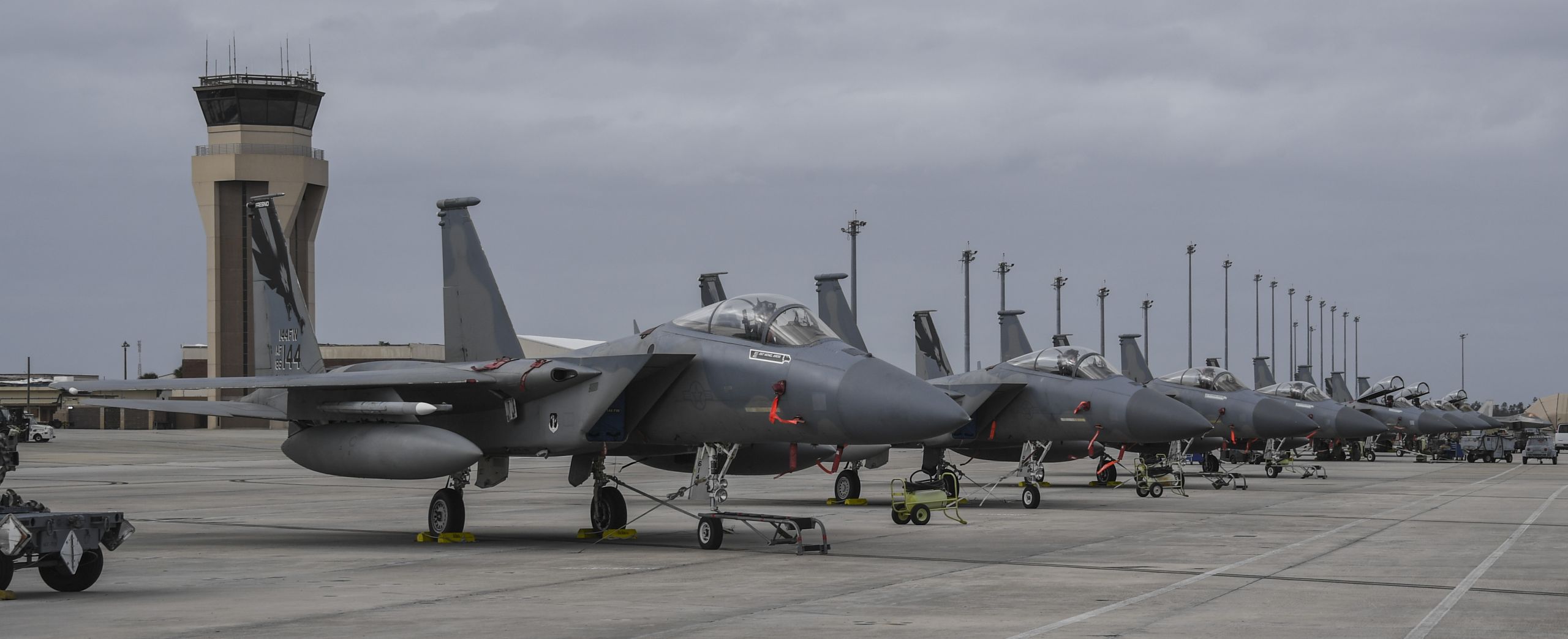 Several jets sit parked on a runway