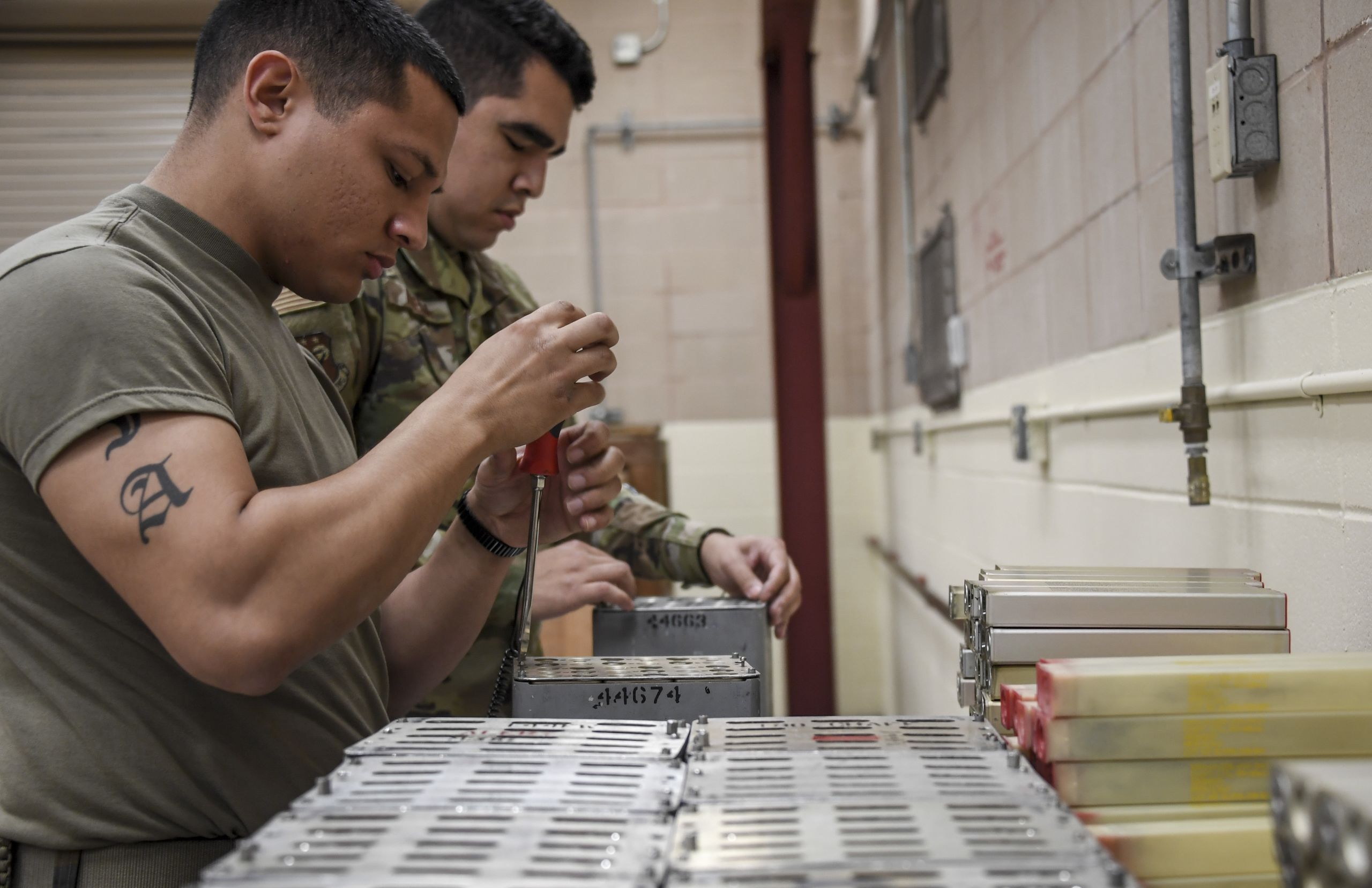 Airmen package items in military containers.