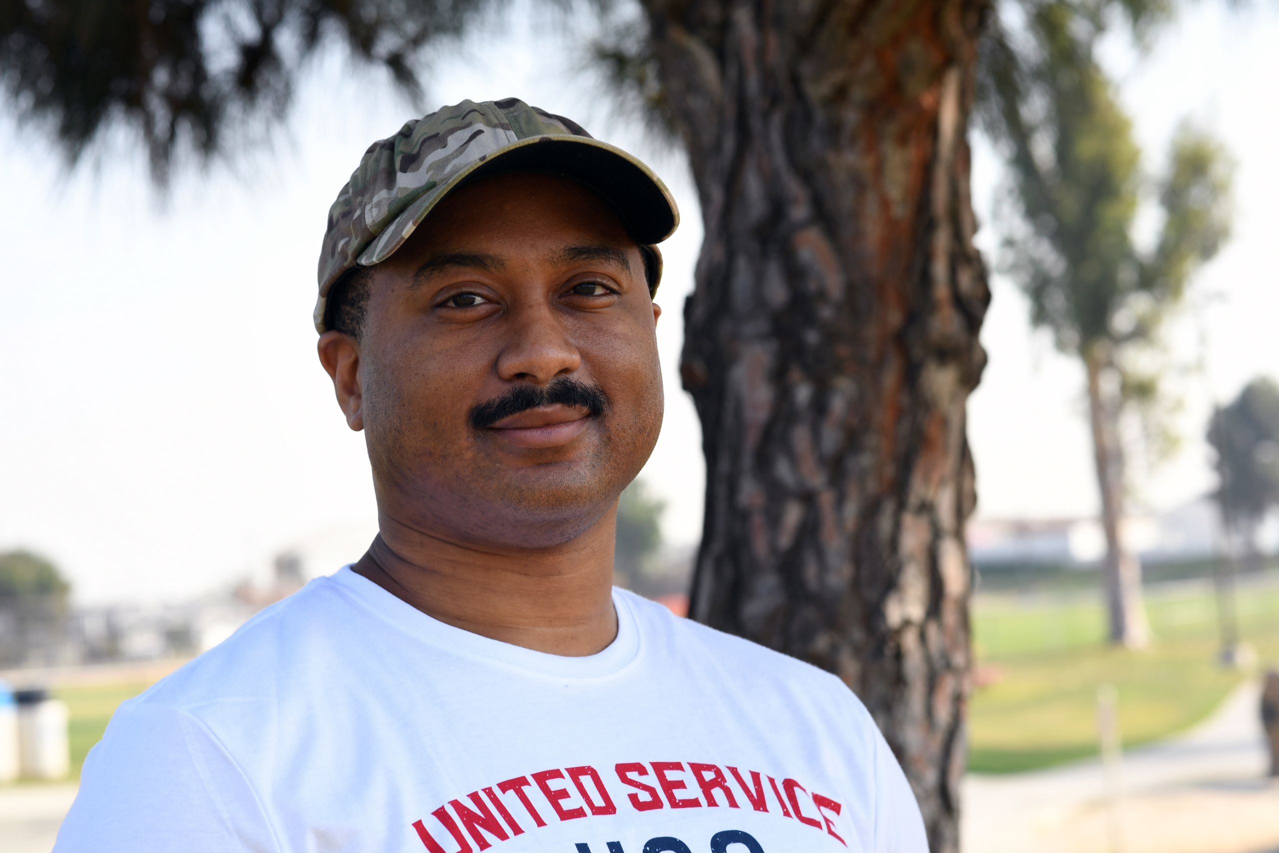 Soldier in white shirt and ball cap