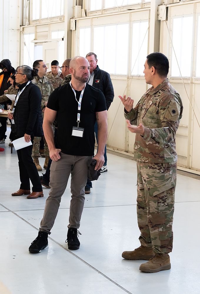 Soldier talks to civilian man.