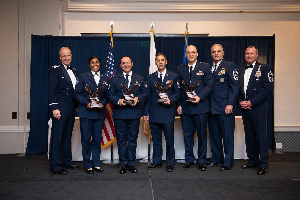 Award recipients holding trophies.
