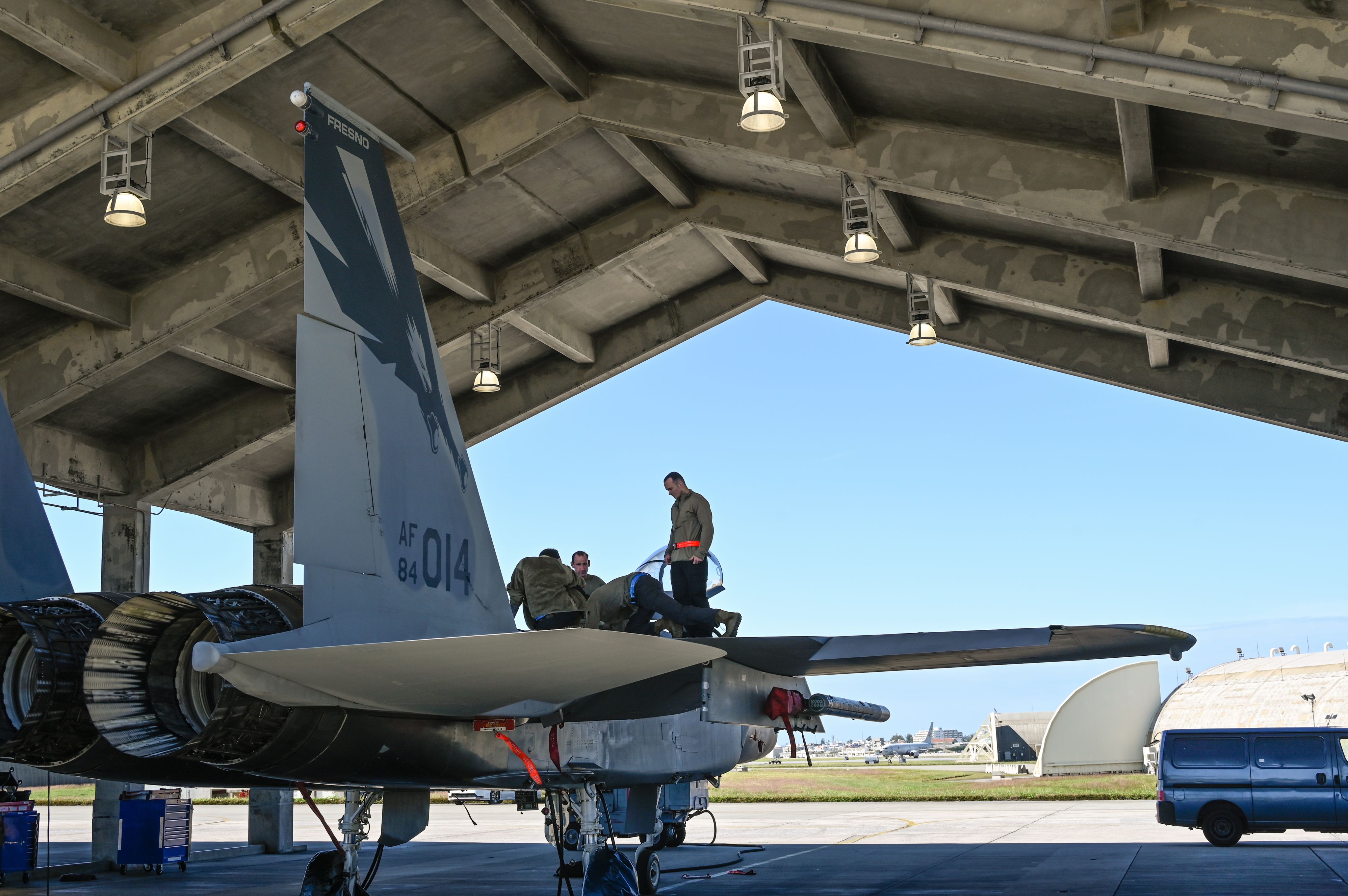 Airmen perform repairs on jet.