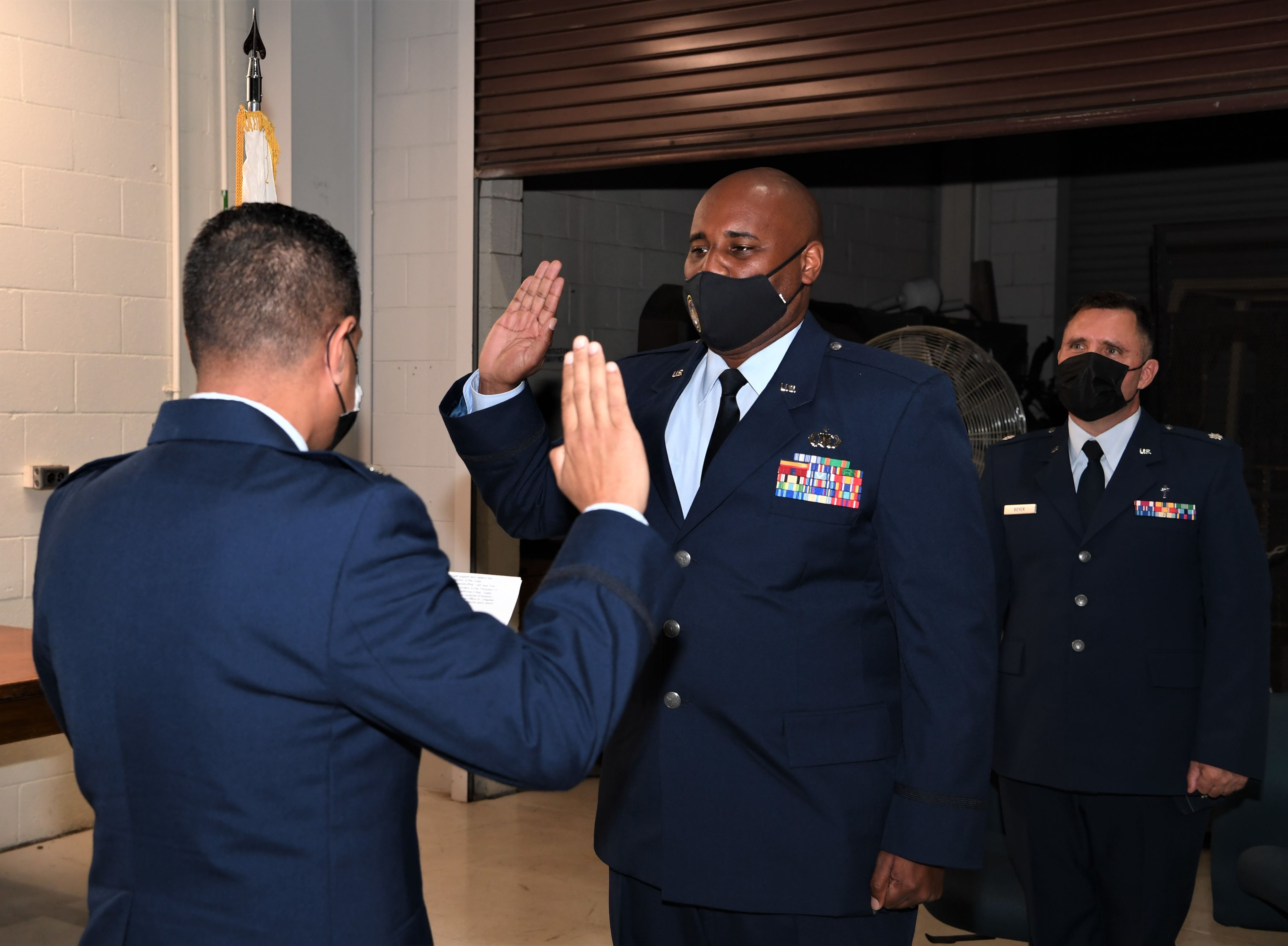 Airman raises hand to recite oath.