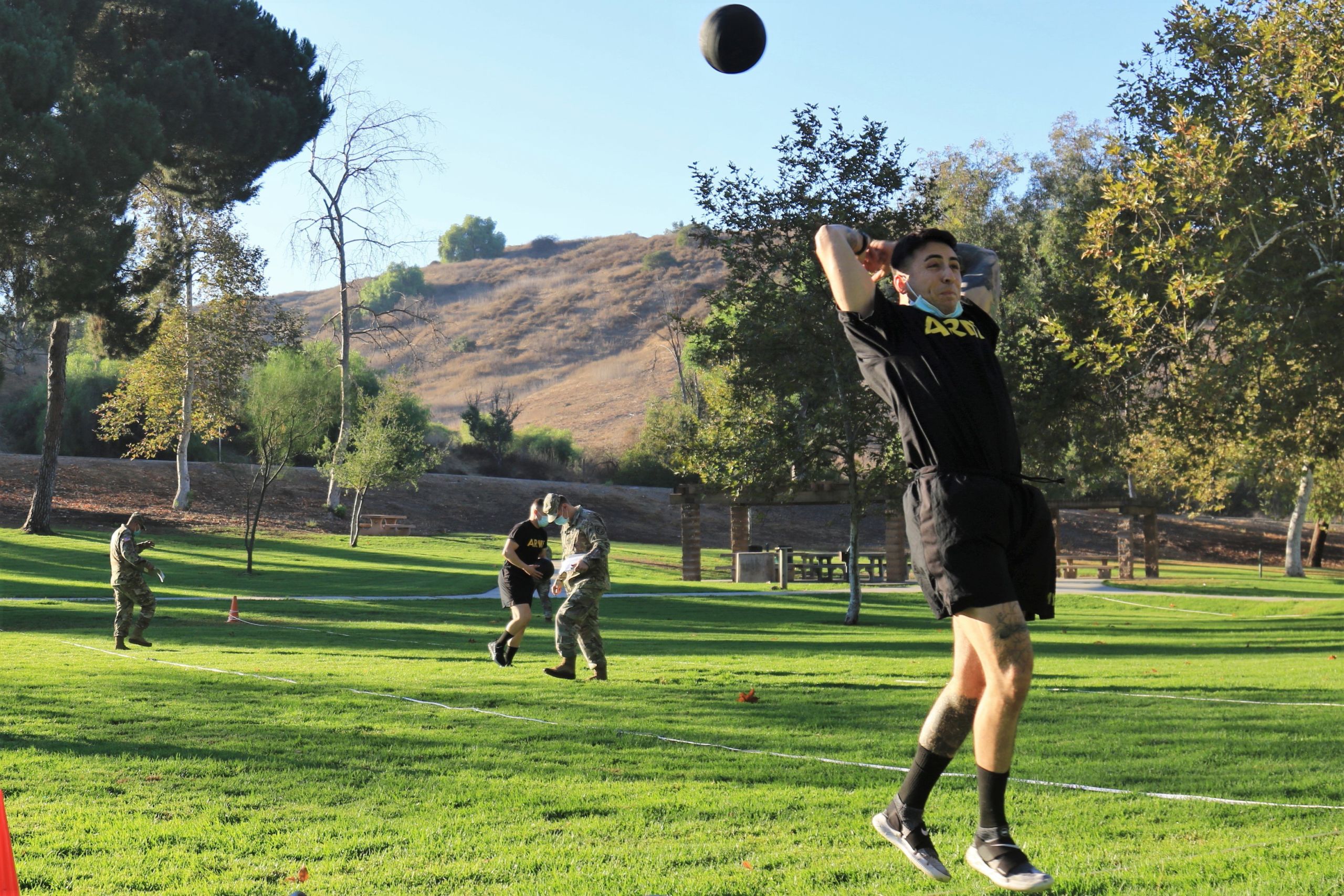 Soldier throws medicine ball.