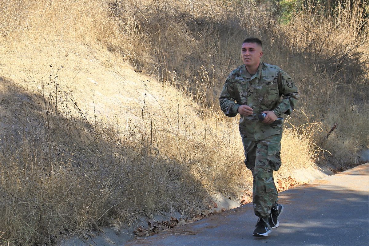 Soldier runs up a hill.