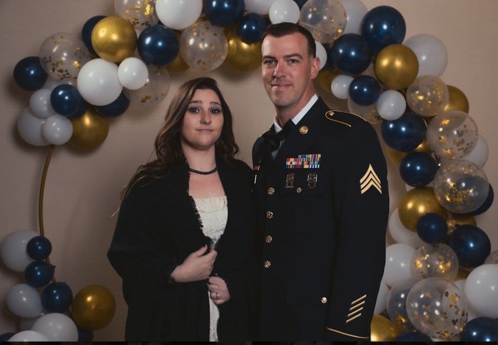 woman stands with man in uniform