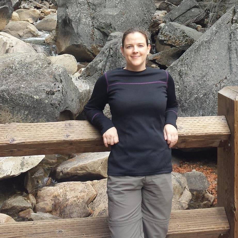 Woman rests on hiking trail path