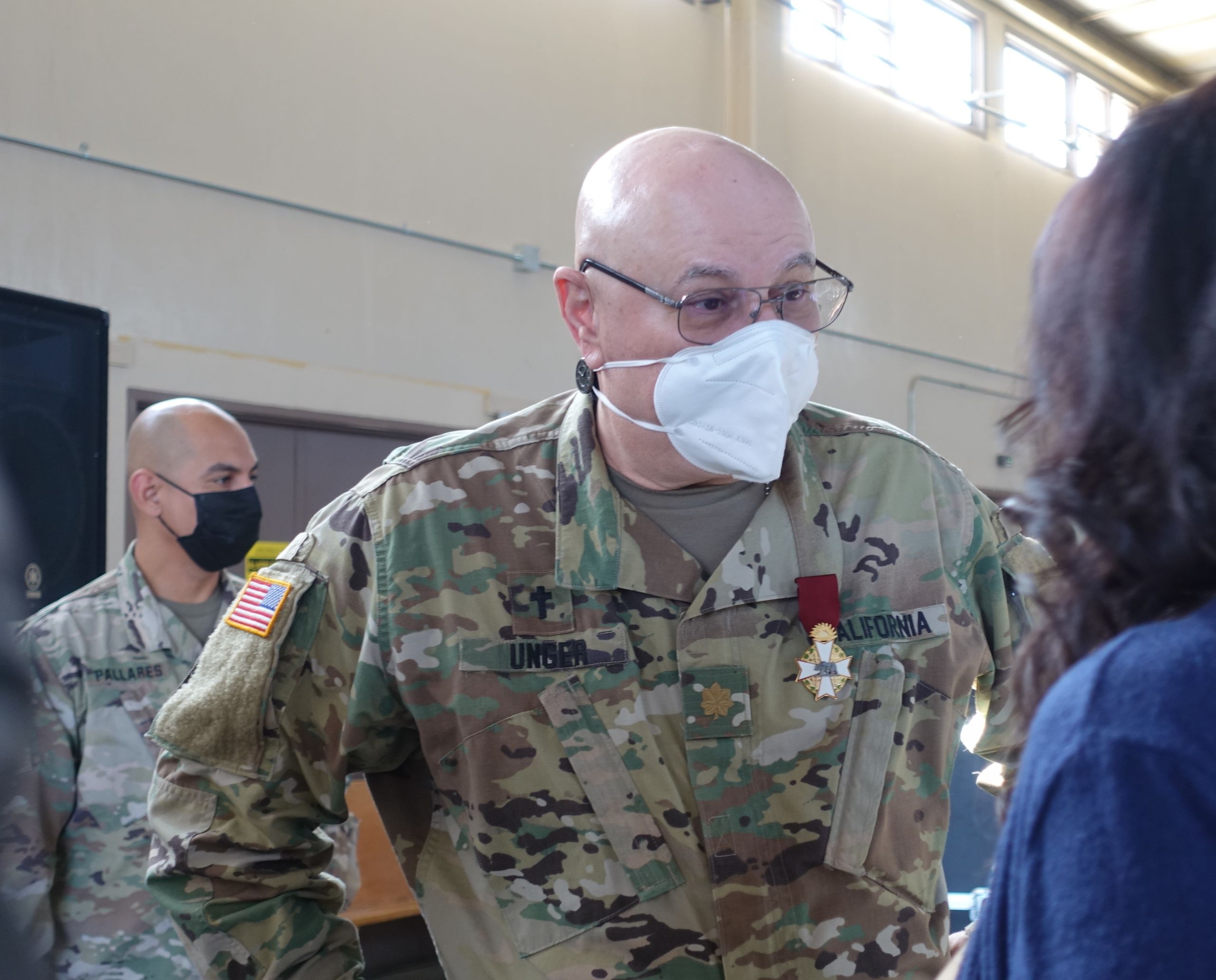 California State Guard Maj. Marc Unger, chaplain, speaks with members of the audience.
