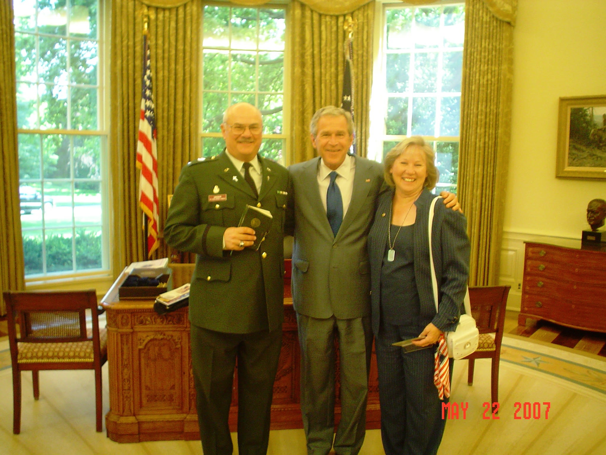 Chaplain Unger poses with President George W. Bush and wife, Lynda, in the Oval office of the White House.