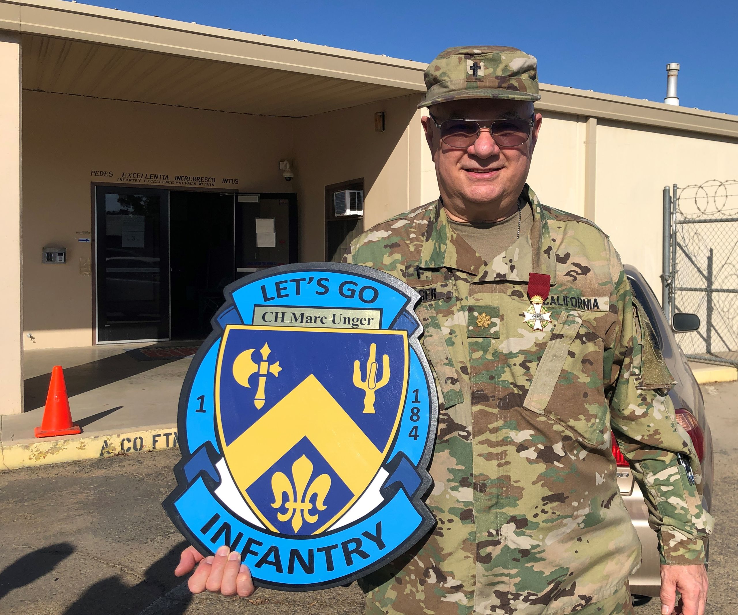 California State Guardsman poses with shield presented by 1st Battalion, 184 Infantry Regiment award.