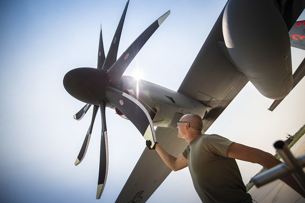 Airman checks propeller blade.