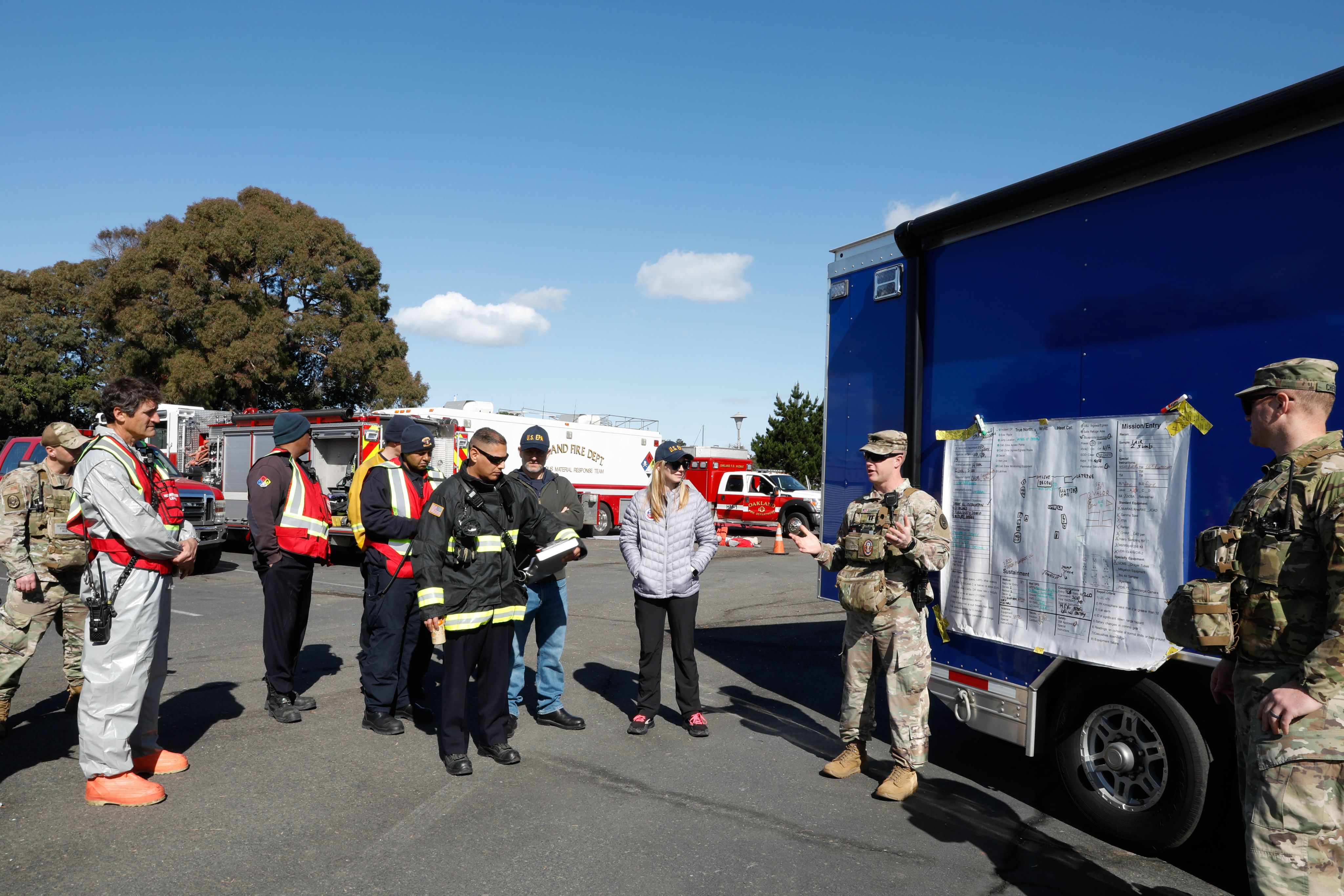 Soldier briefs firefighters.