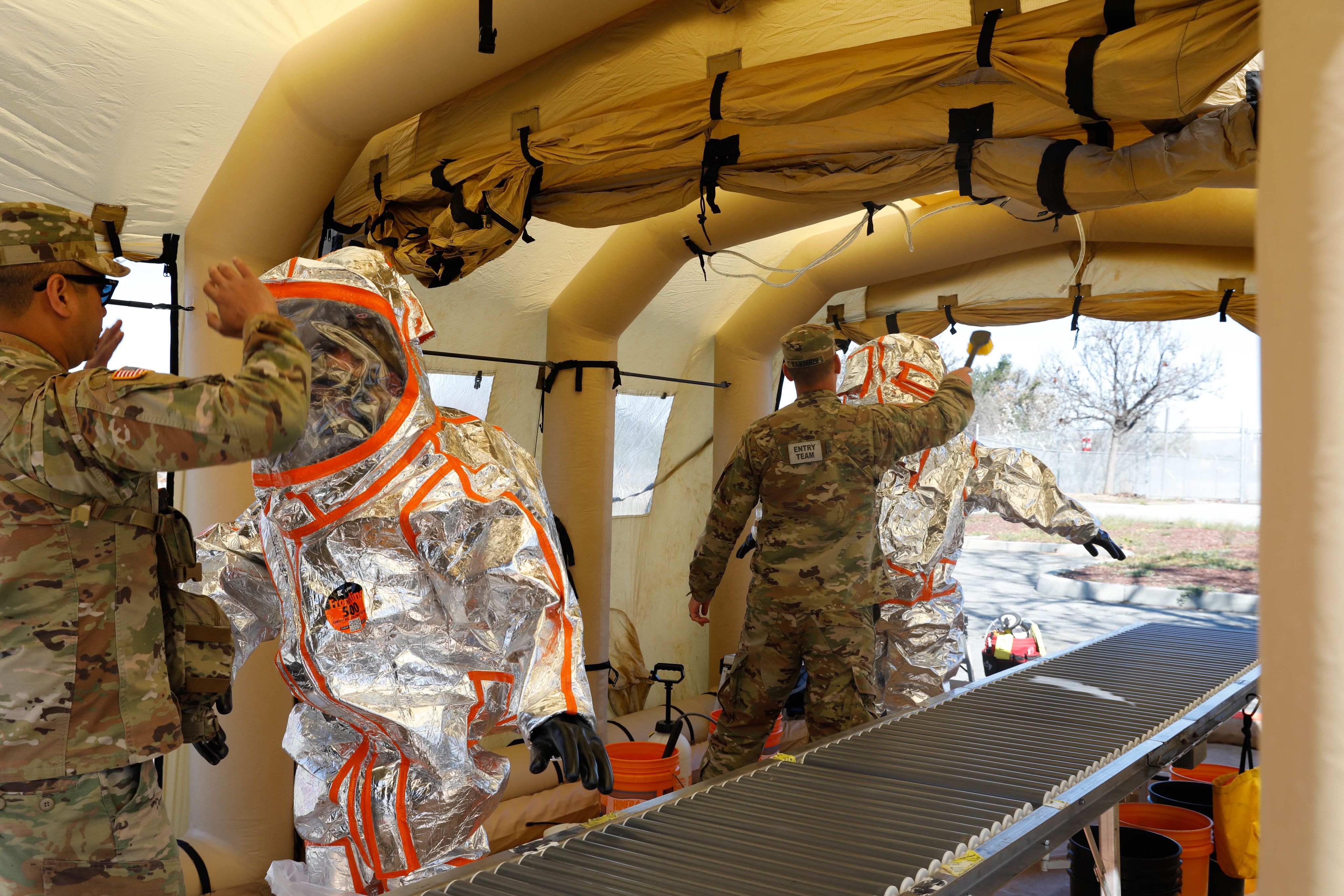 People in decontamination tent.