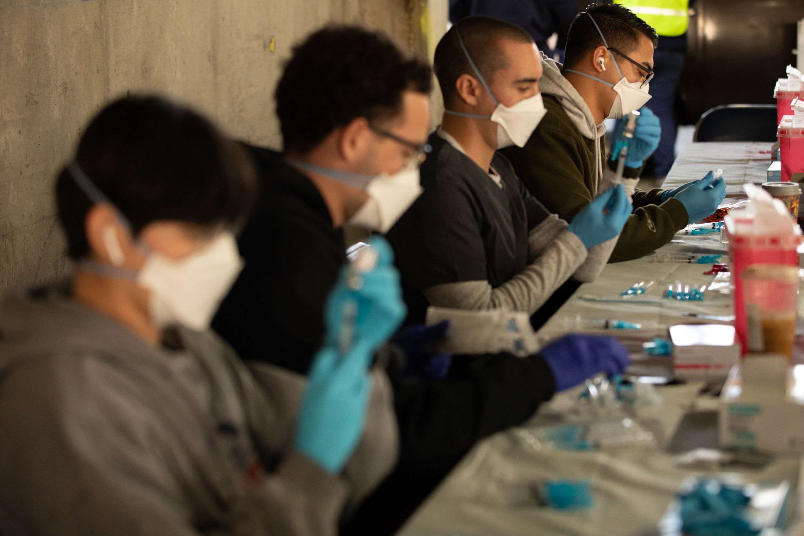 U.S. Army Soldiers with the California National Guard prep syringes that will be used to administer the Moderna COVID-19 vaccine at the Long Beach Convention and Entertainment Center, California, March 16, 2021. Nearly 70 service members with the Cal Guard have been supporting the city of Long Beach at the drive-thru portion of the community vaccination site. (U.S. Army National Guard photo by Staff Sgt. Kimberly Hill)