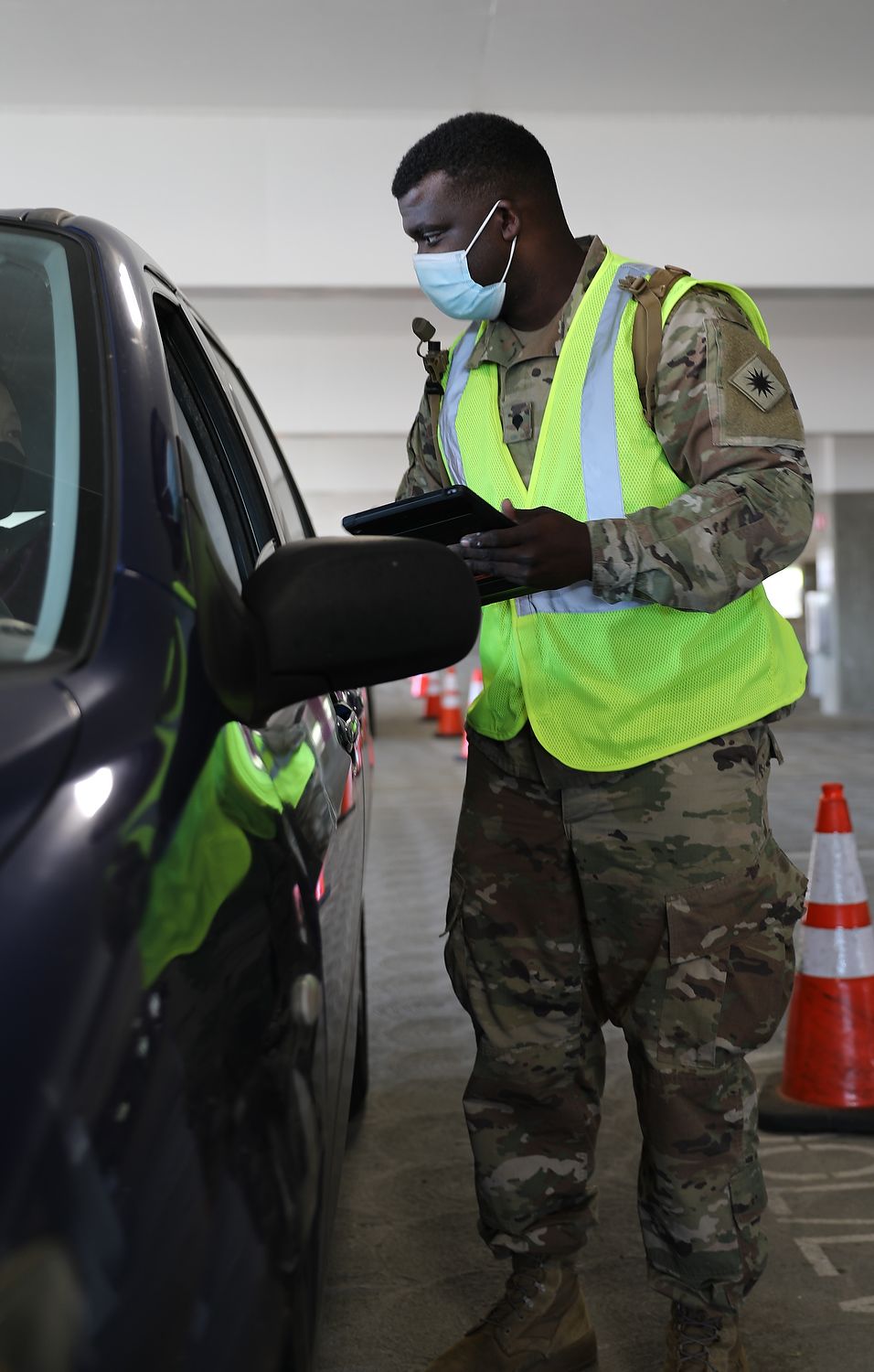 Soldier talks to driver of a car.