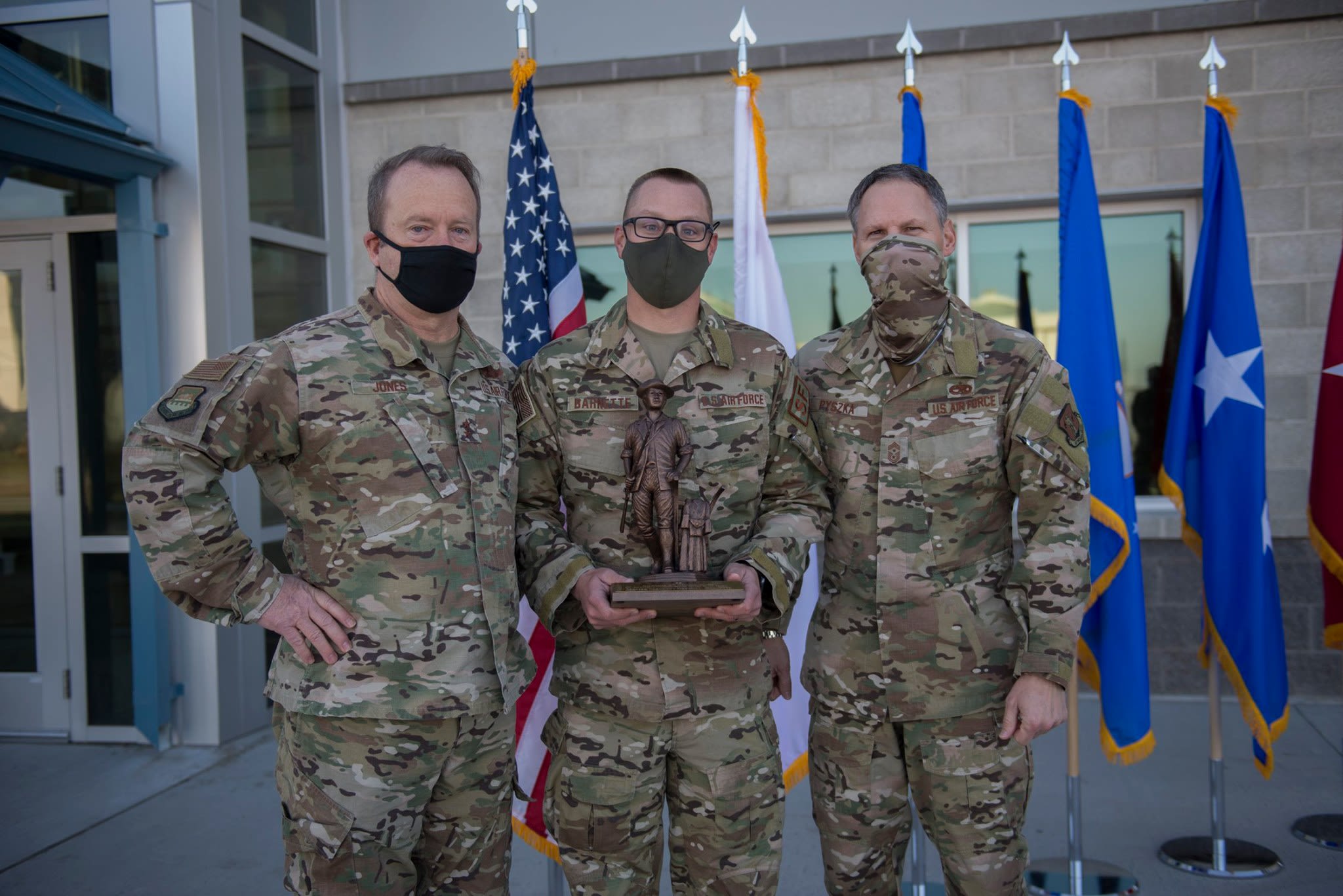 Airman receives trophy.