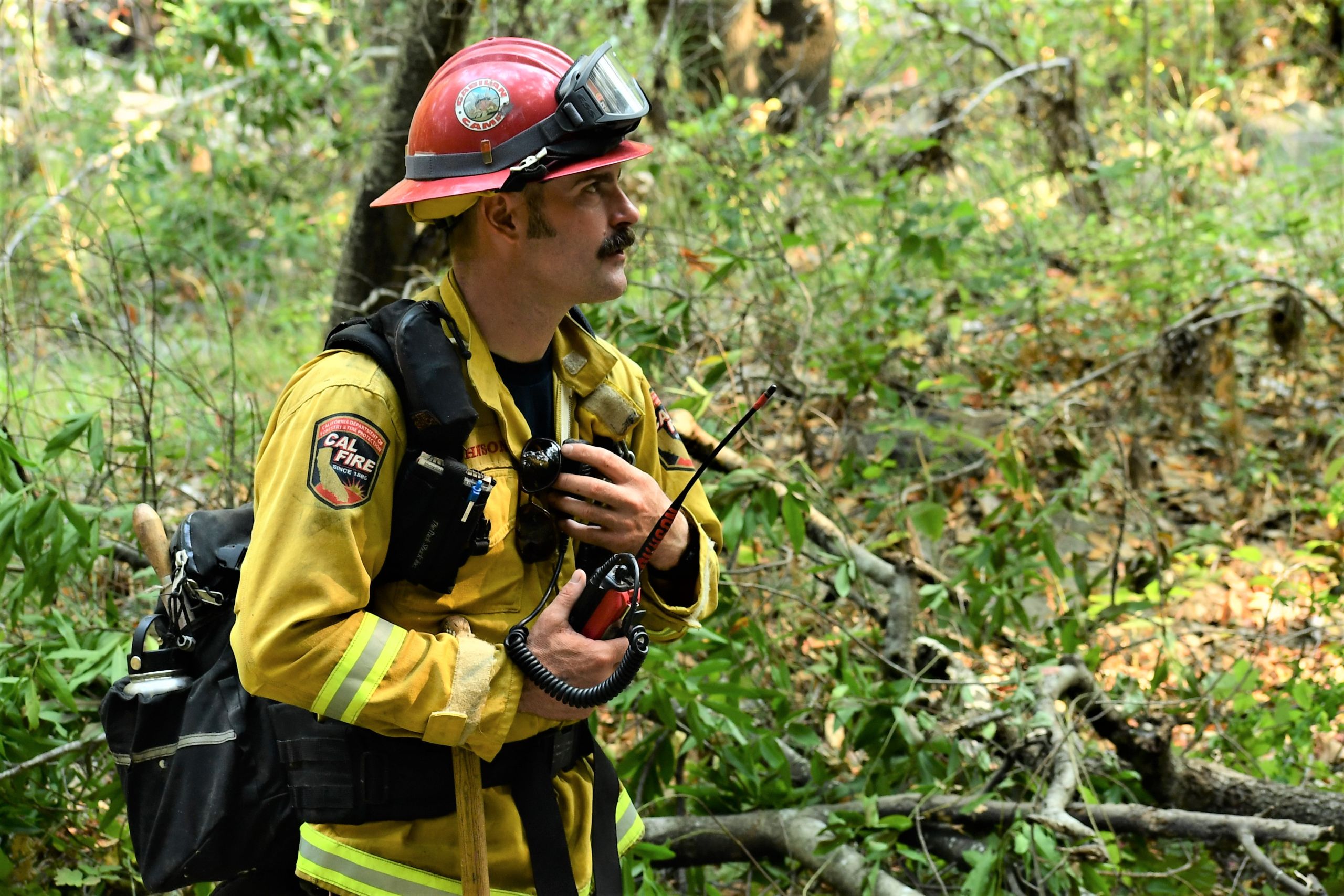 CAL FIRE captain checks his radio for communications regarding updates on the Carmel Fire.