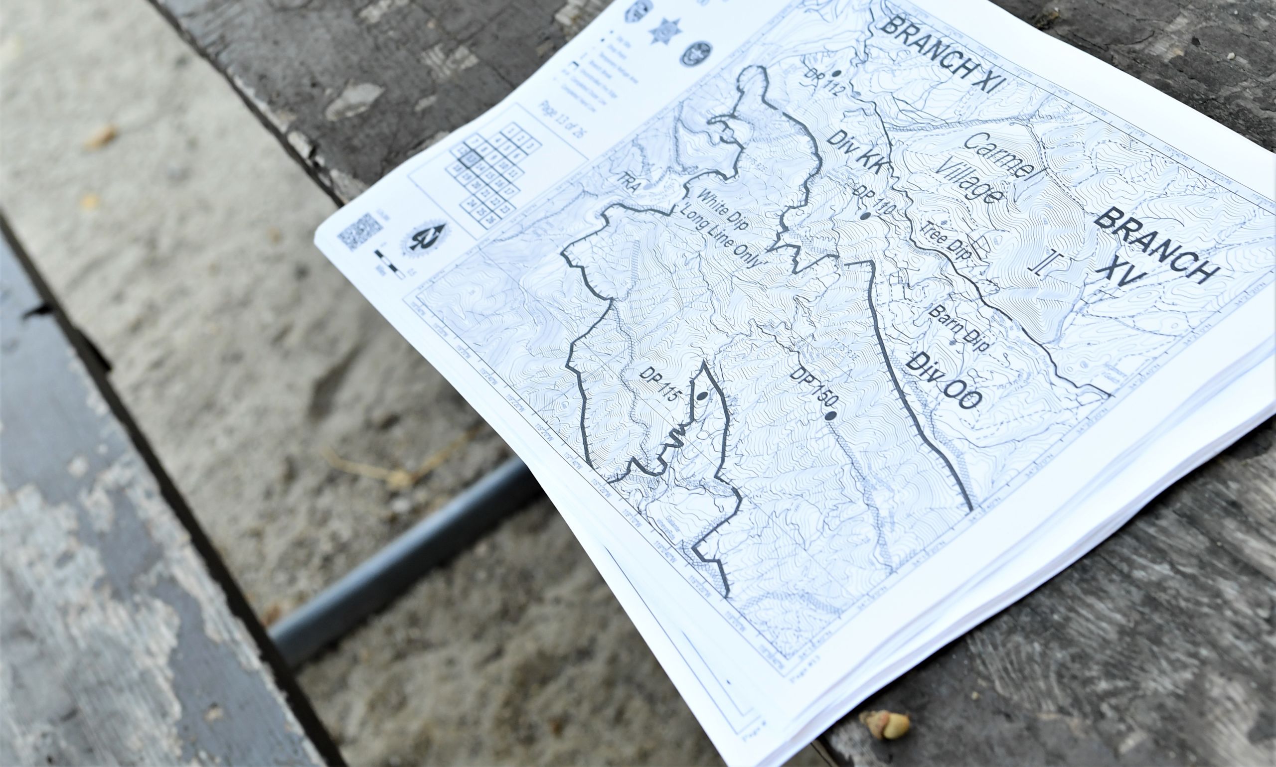 A map of the Carmel Fire incident sits on a wooden picnic table.