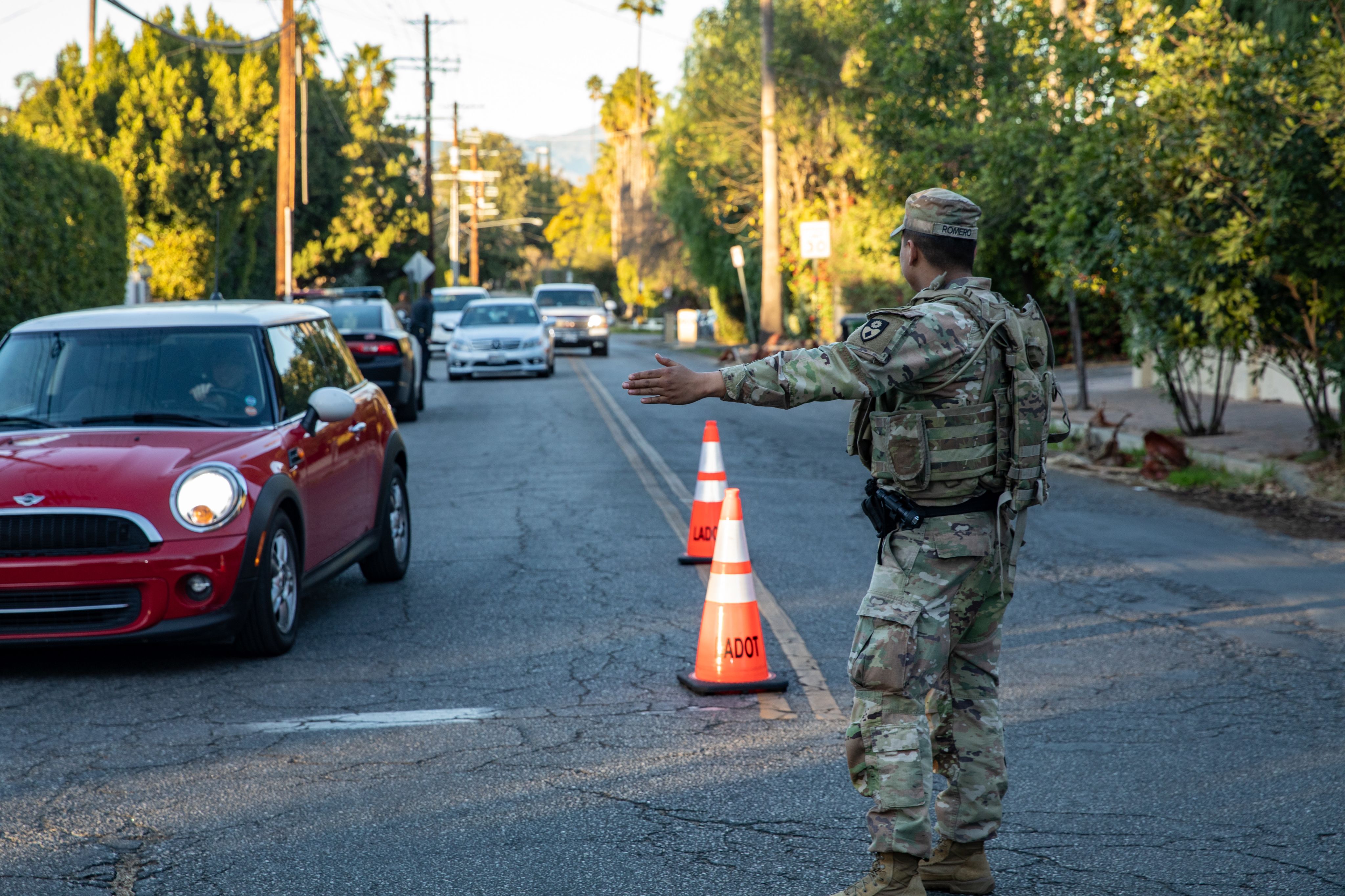 A Soldier directs traffic at an intersection