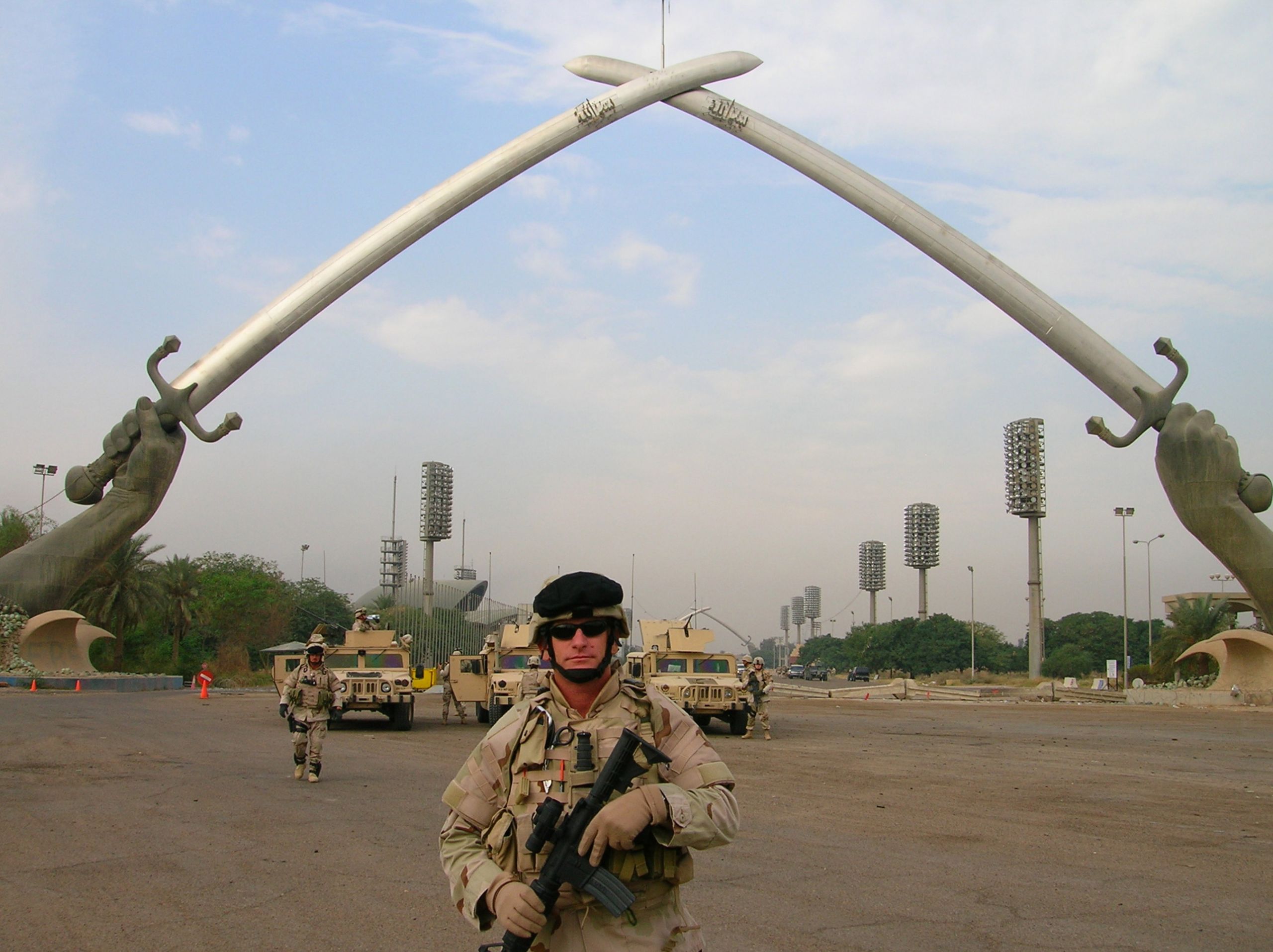 Photo of Soldier below Victory Arch in Iraq.