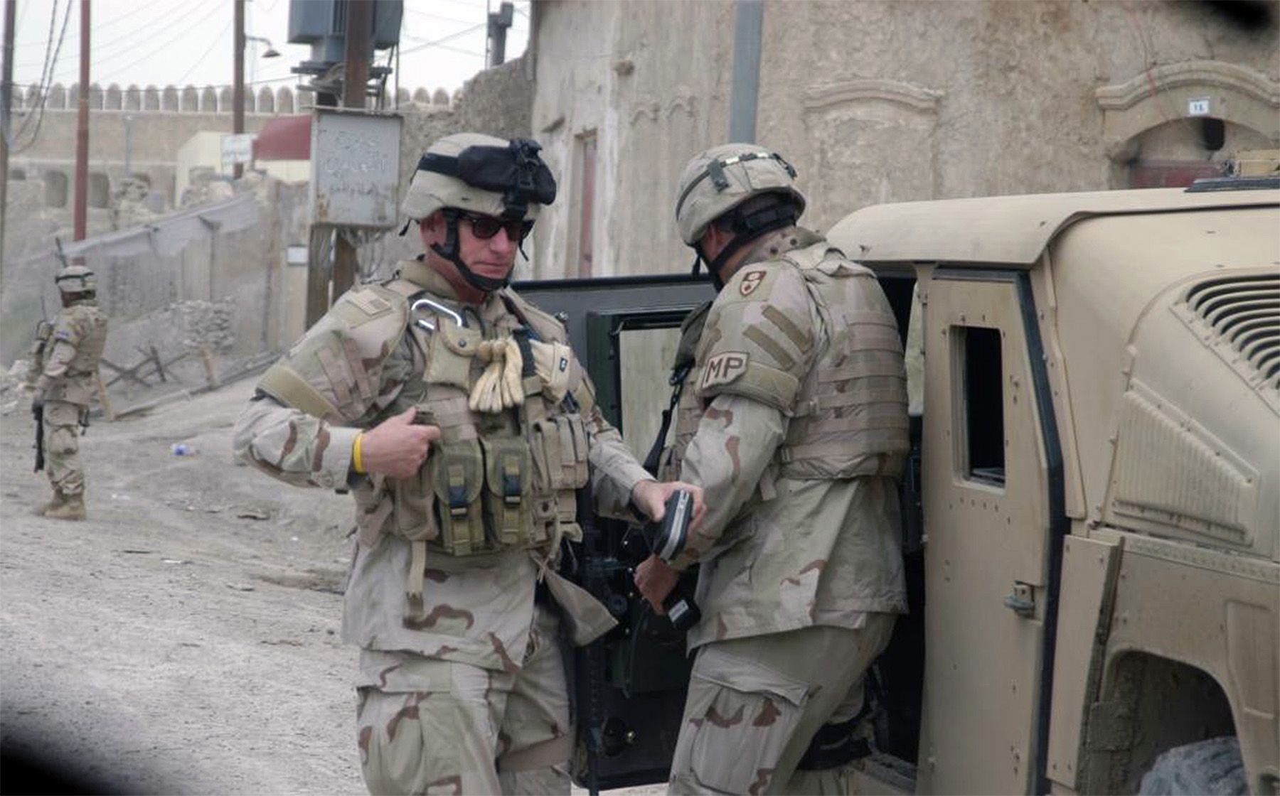 PHOTO OF 2 SOLDIERS IN BAGHDAD AT HUMVEE