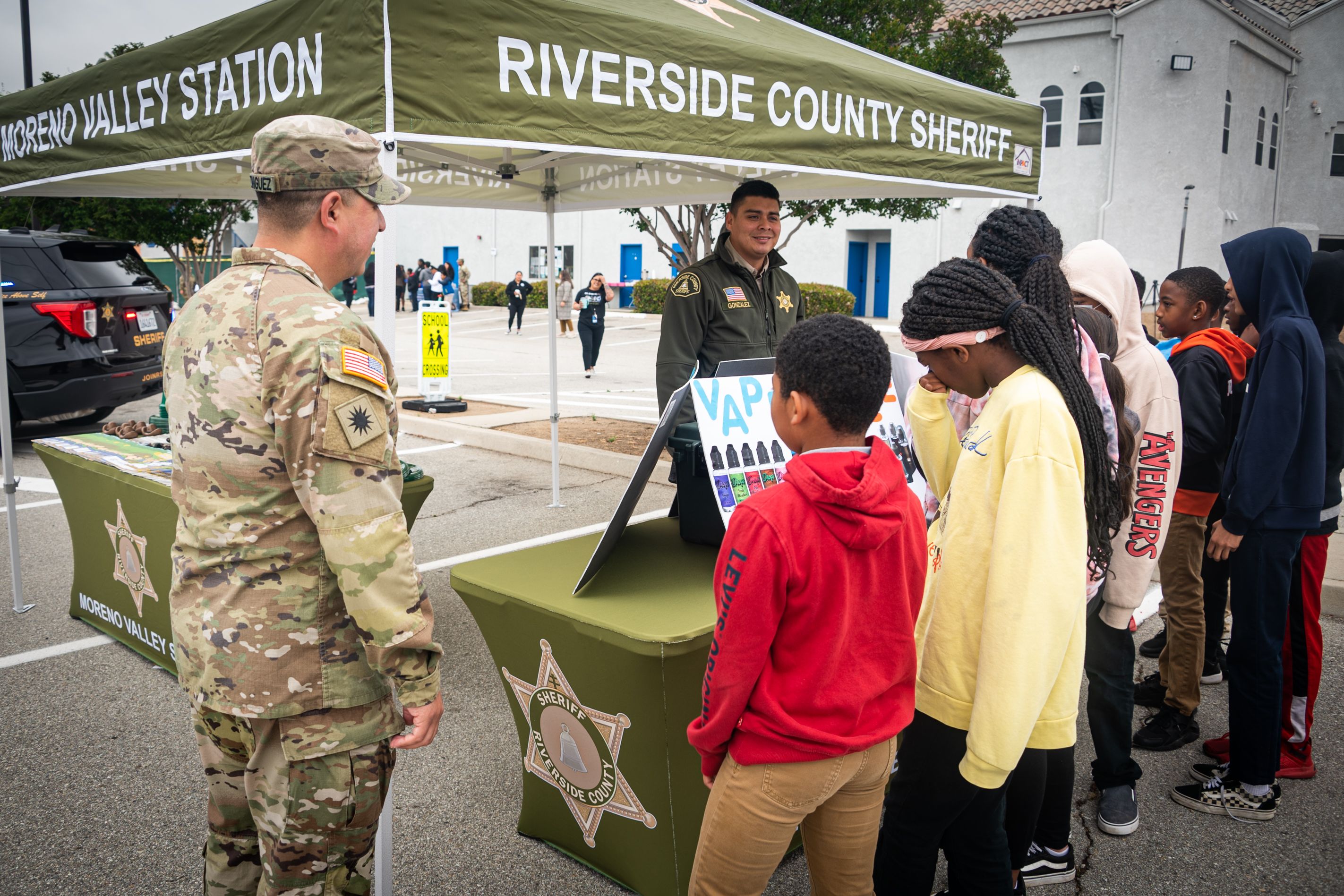Soldier and students attend law enforcement booth