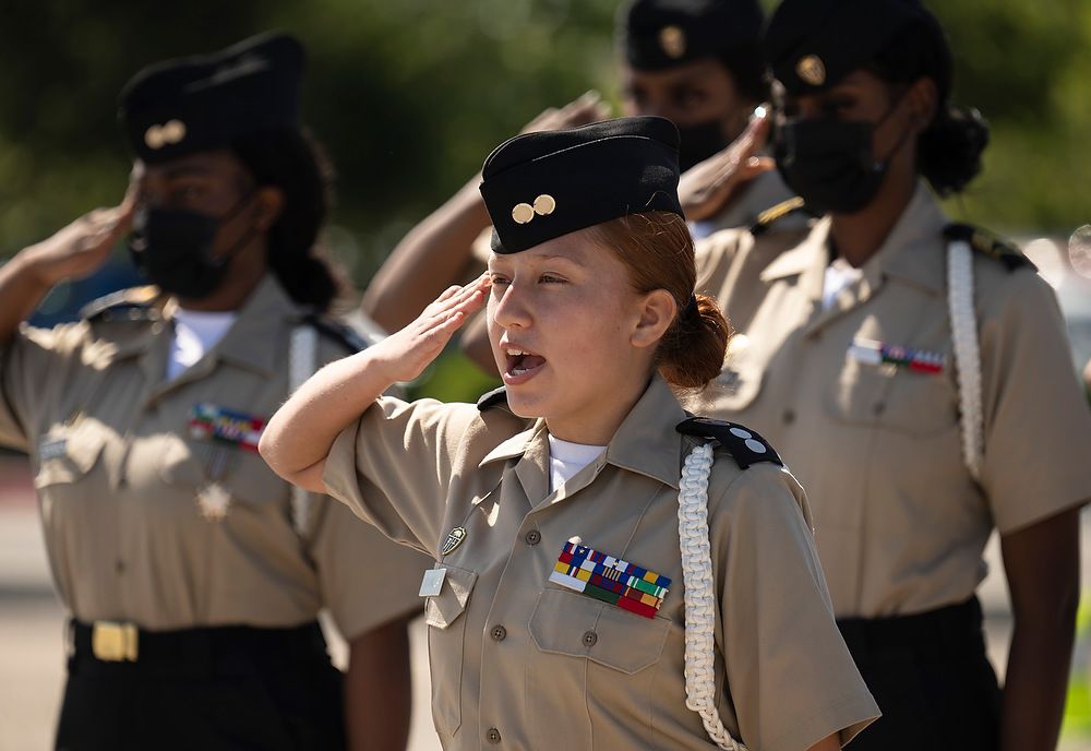 Female cadet salutes.