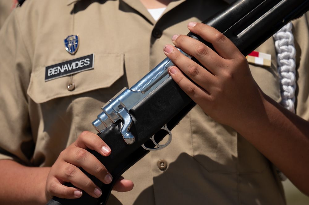 Cadet holds rifle.