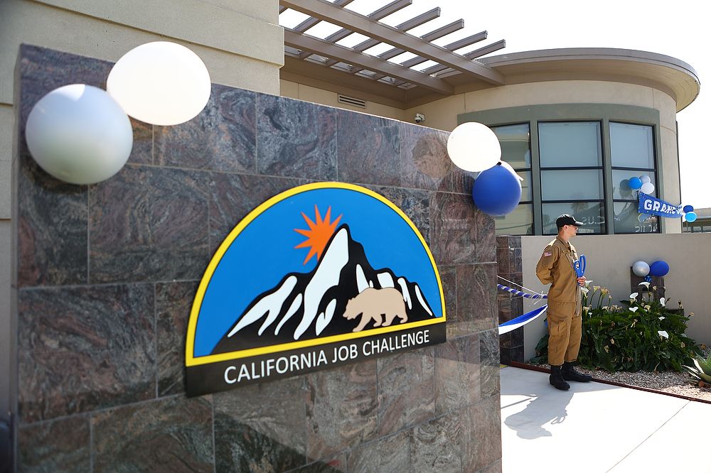 Building sign with balloons displayed.