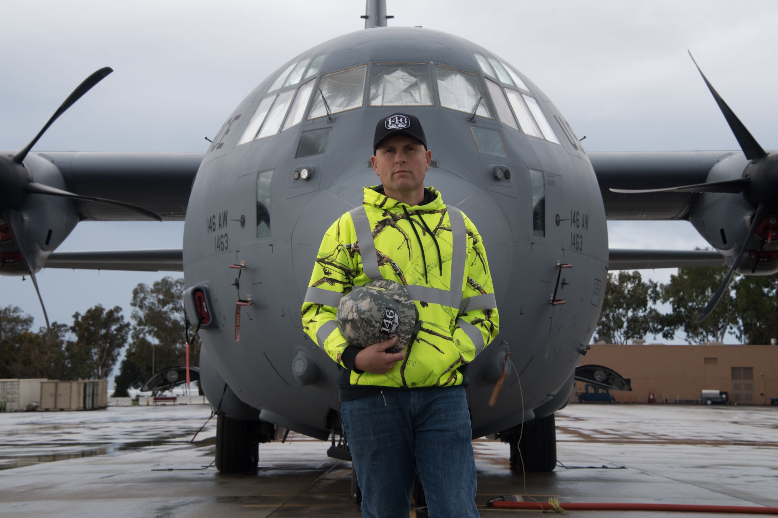 Man stands in front of cargo aircraft.