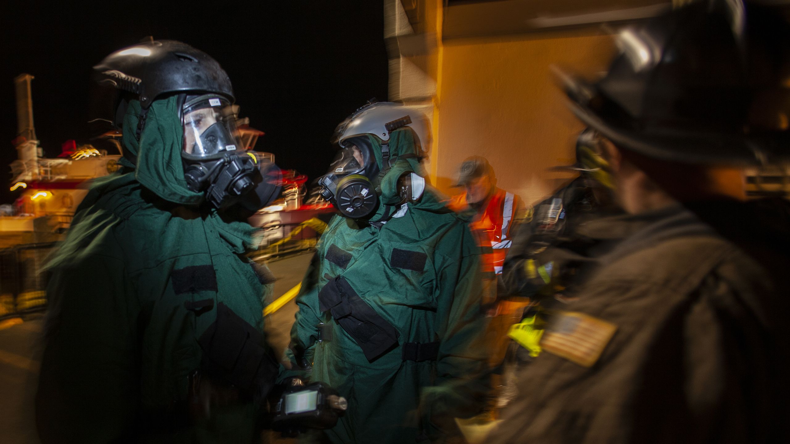 Soldiers in hazardous materials suits.