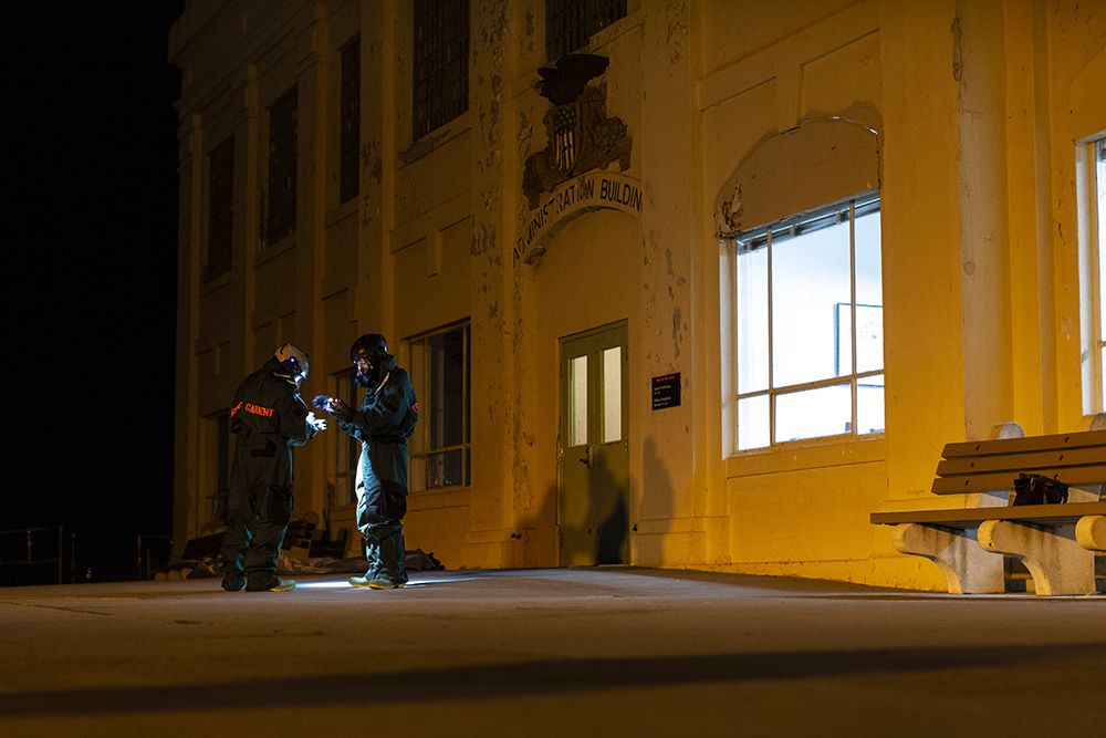 Soldiers in hazardous materials suits.