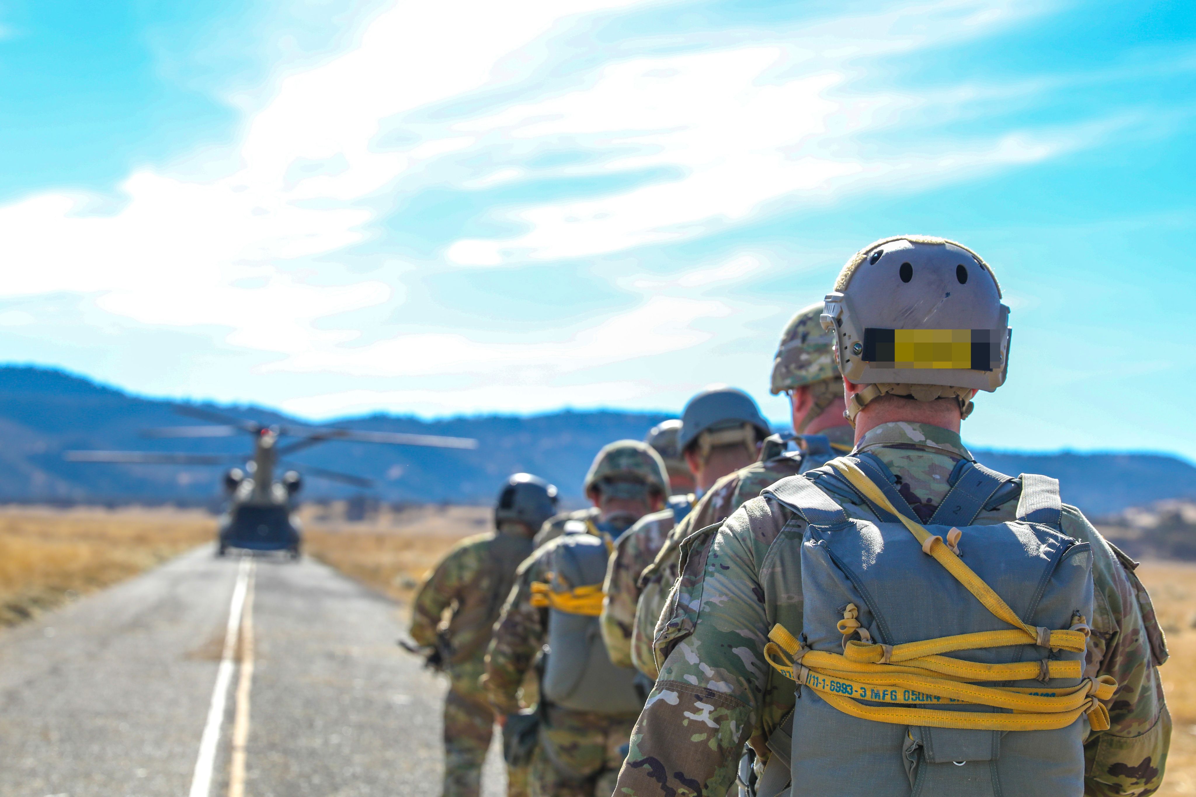 Special Forces soldiers line up to board chinook helicopter