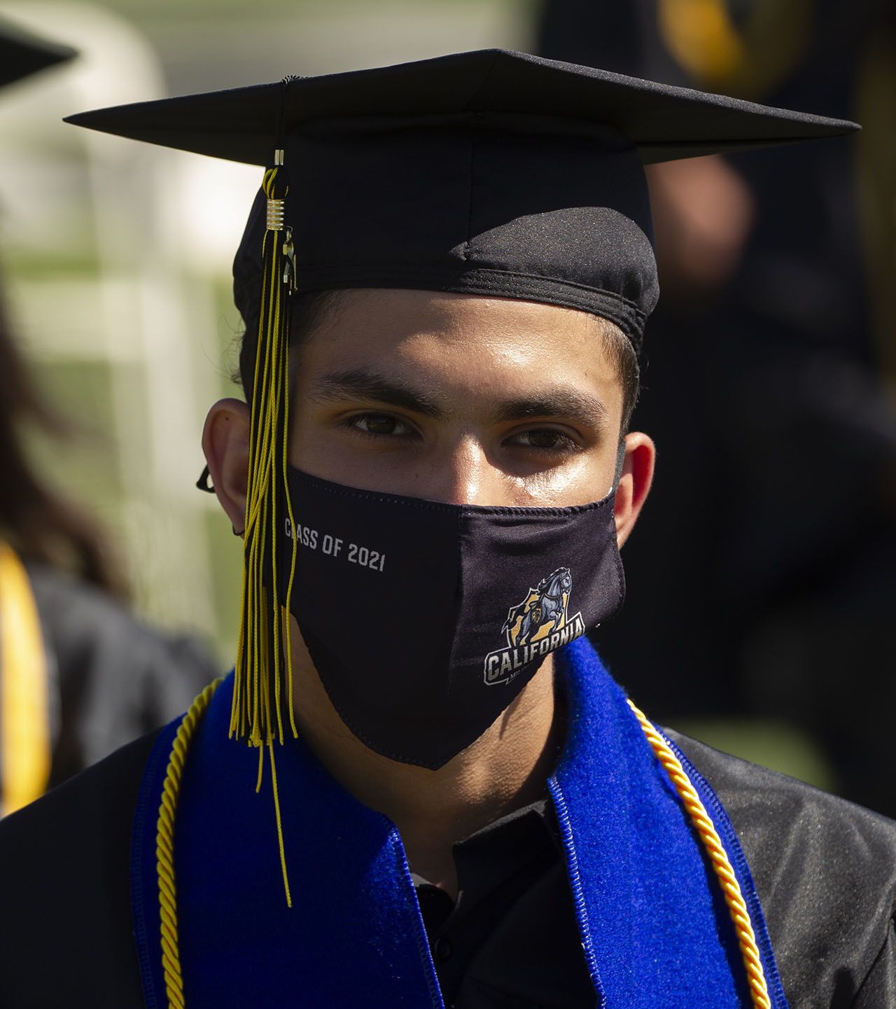 Male high school graduate in cap and gown.