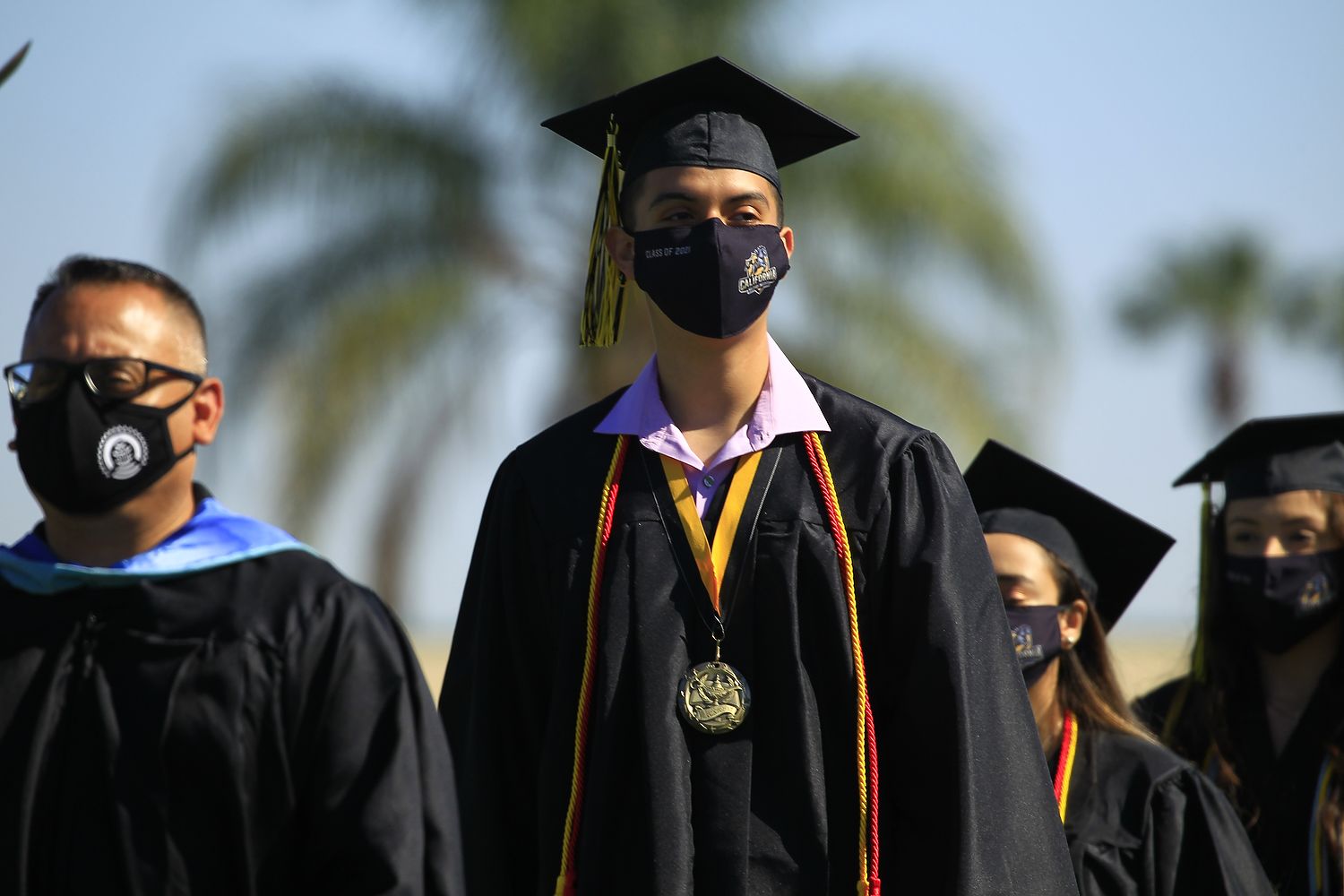 Graduate with valedictorian medal.