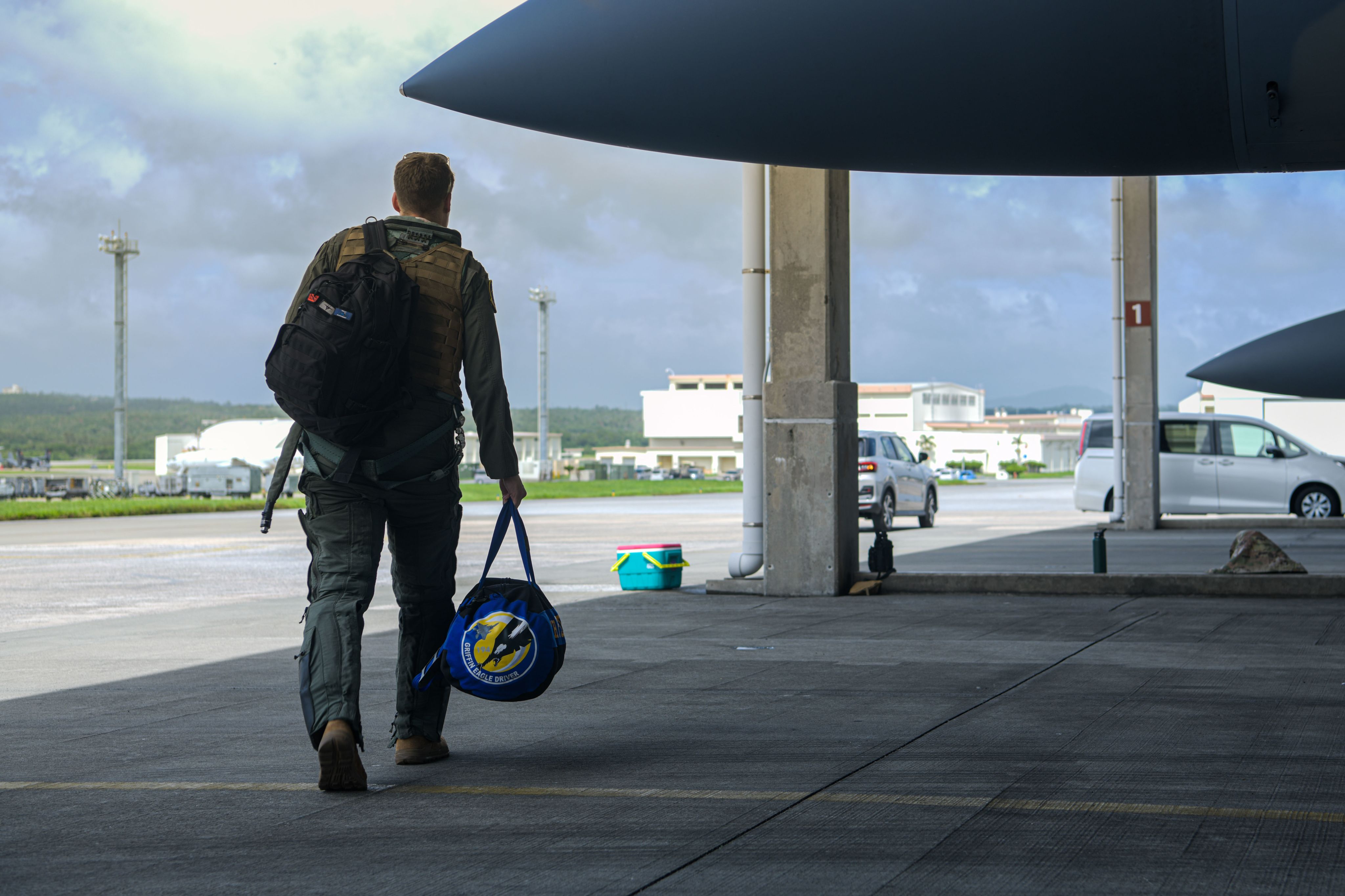 Pilot carries bag off flightline