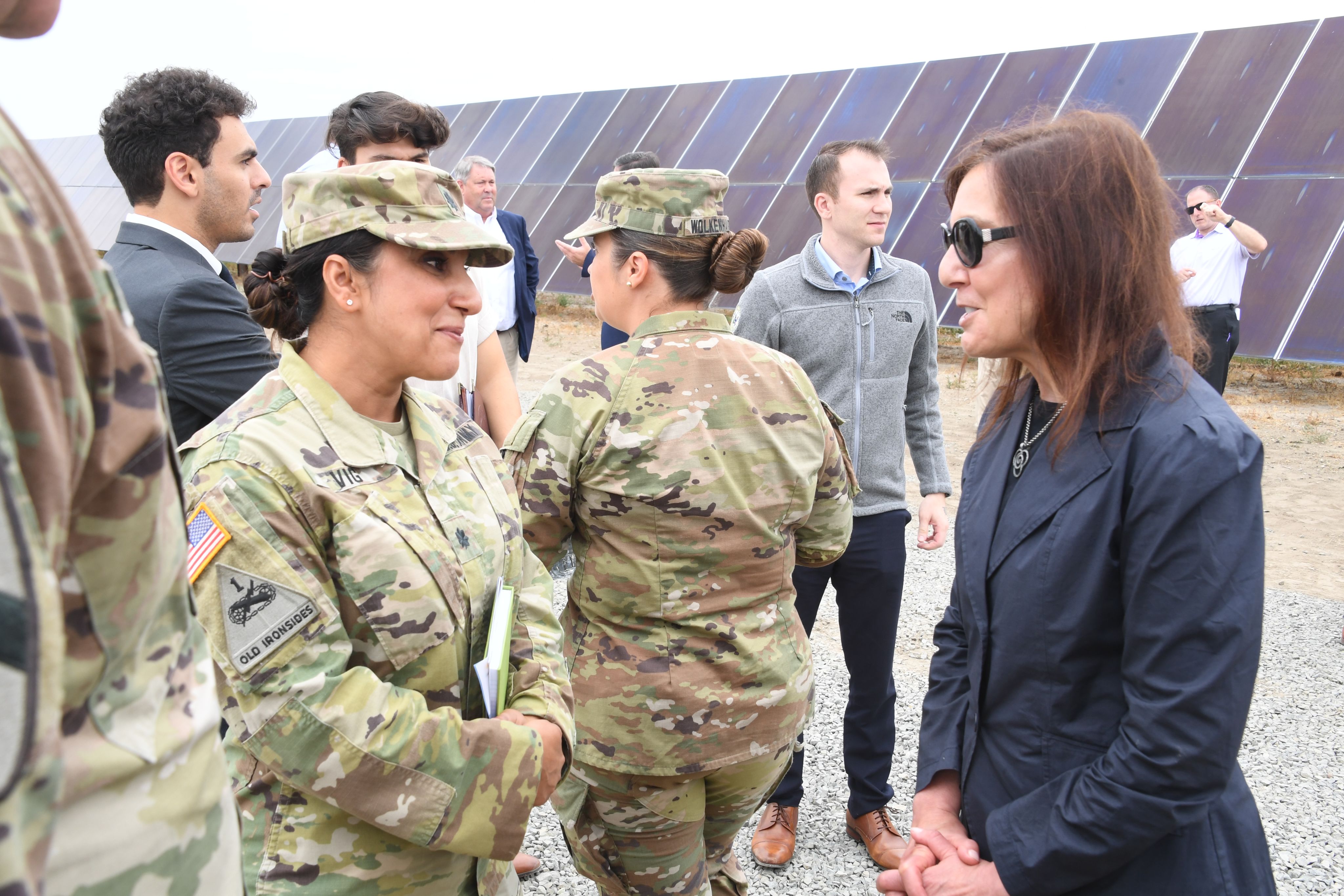 Women standing together, speaking.