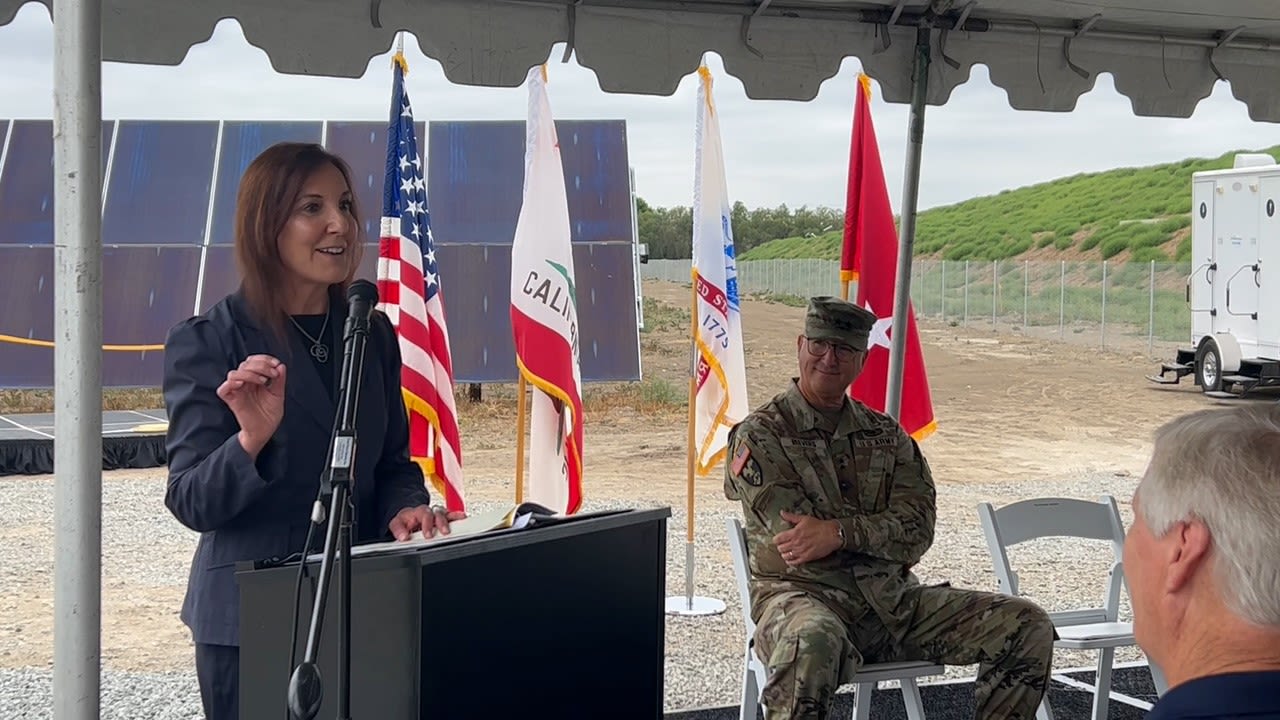 Woman speaks in front of crowd at podium