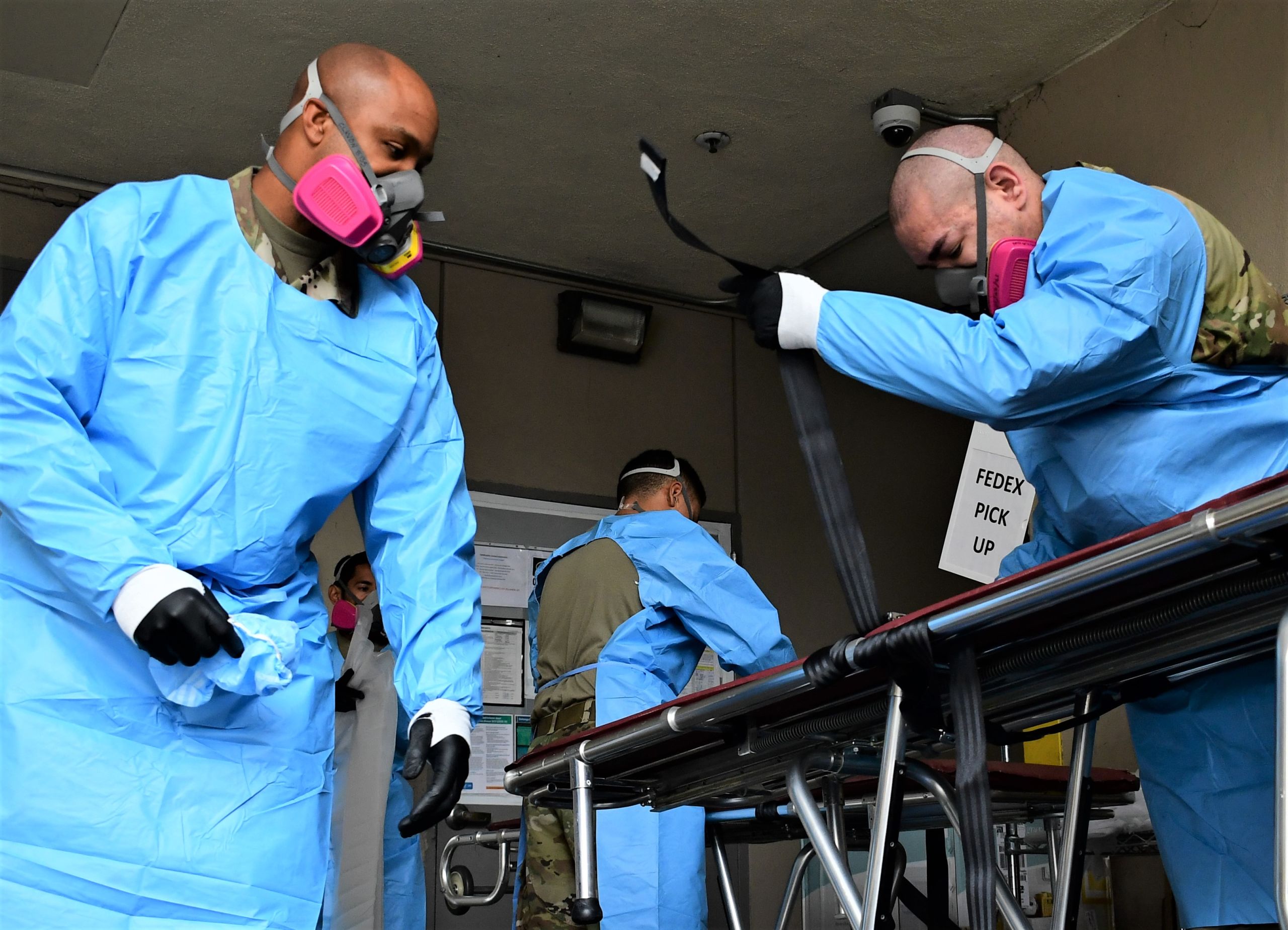 California National Guardsmen prepare wheeled gurneys to transport the deceased from a local hospital