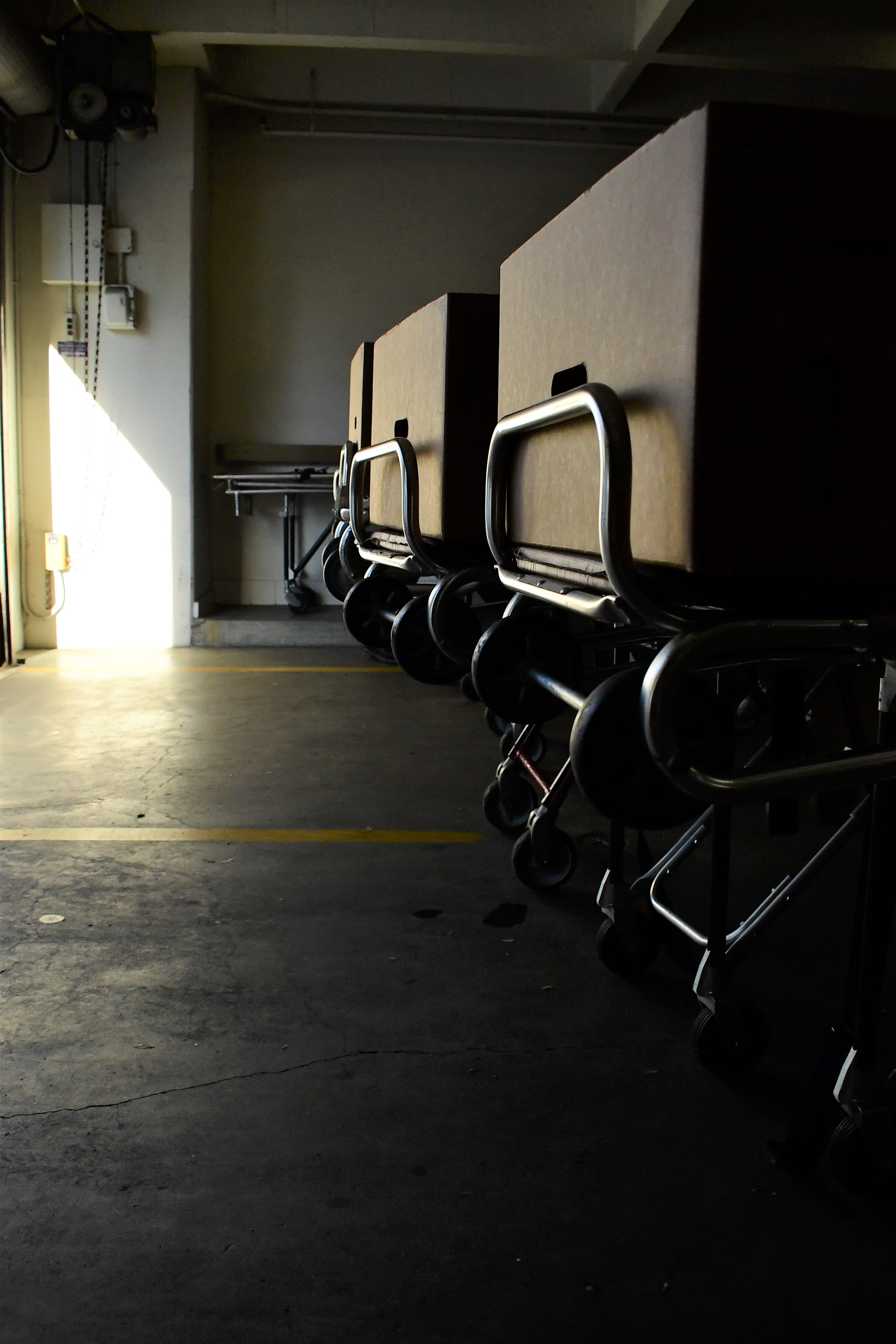 Wheeled gurneys with empty cardboard boxes are staged at the rear entrance to the crypt awaiting for California National Guardsmen to transport the deceased.