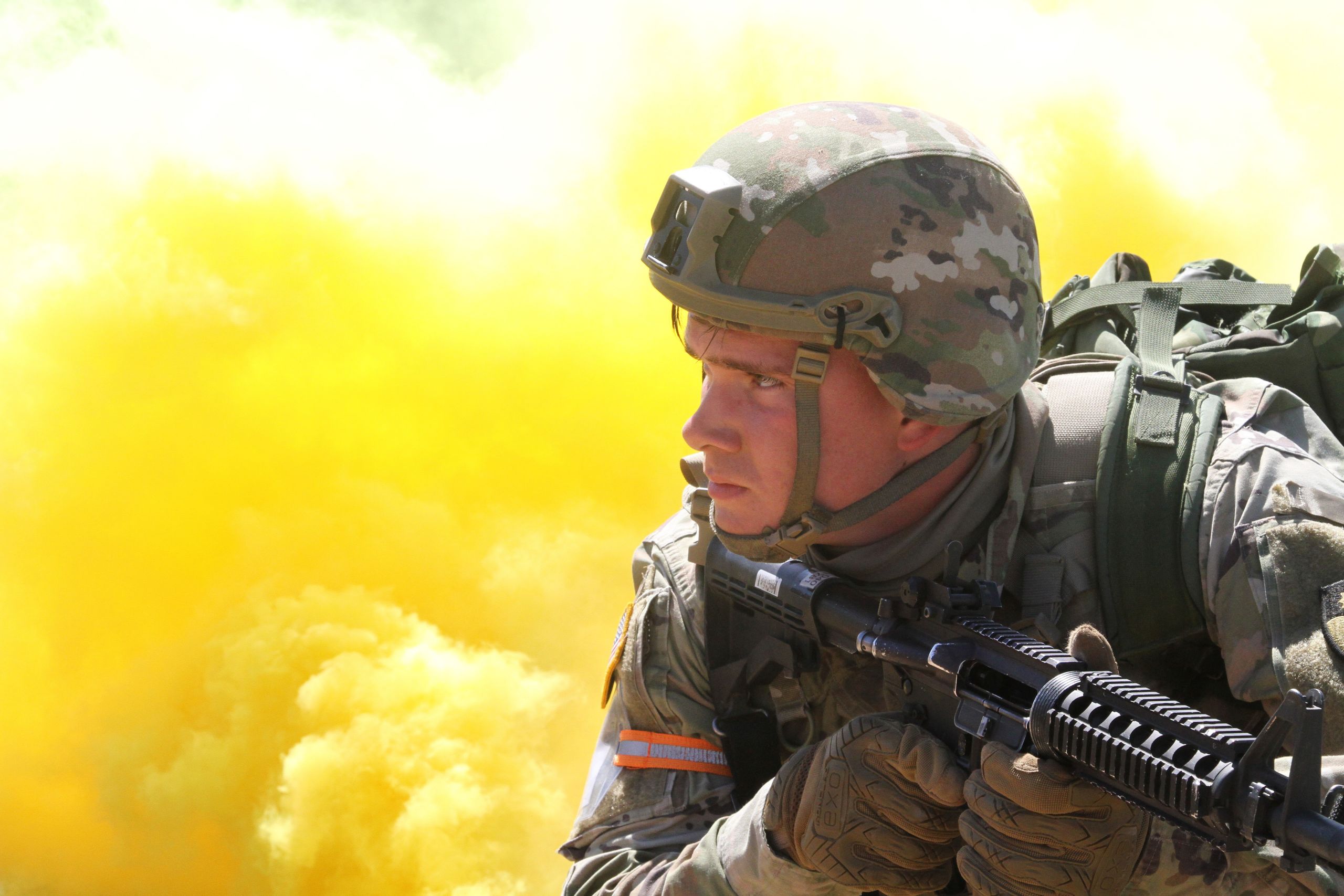 PHOTO OF YELLOW SMOKE SURROUNDING SOLDIER