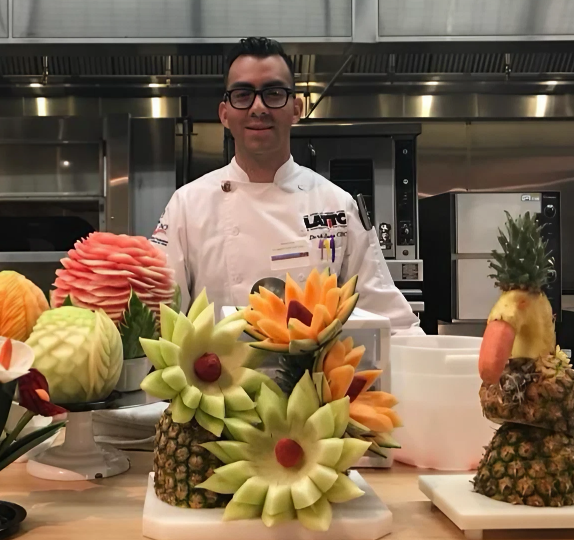 man stands in front of carved fruit