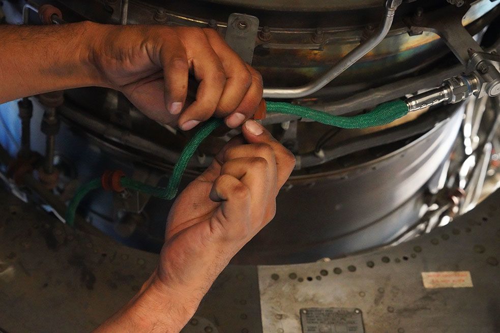 Detail of hands working on engine.