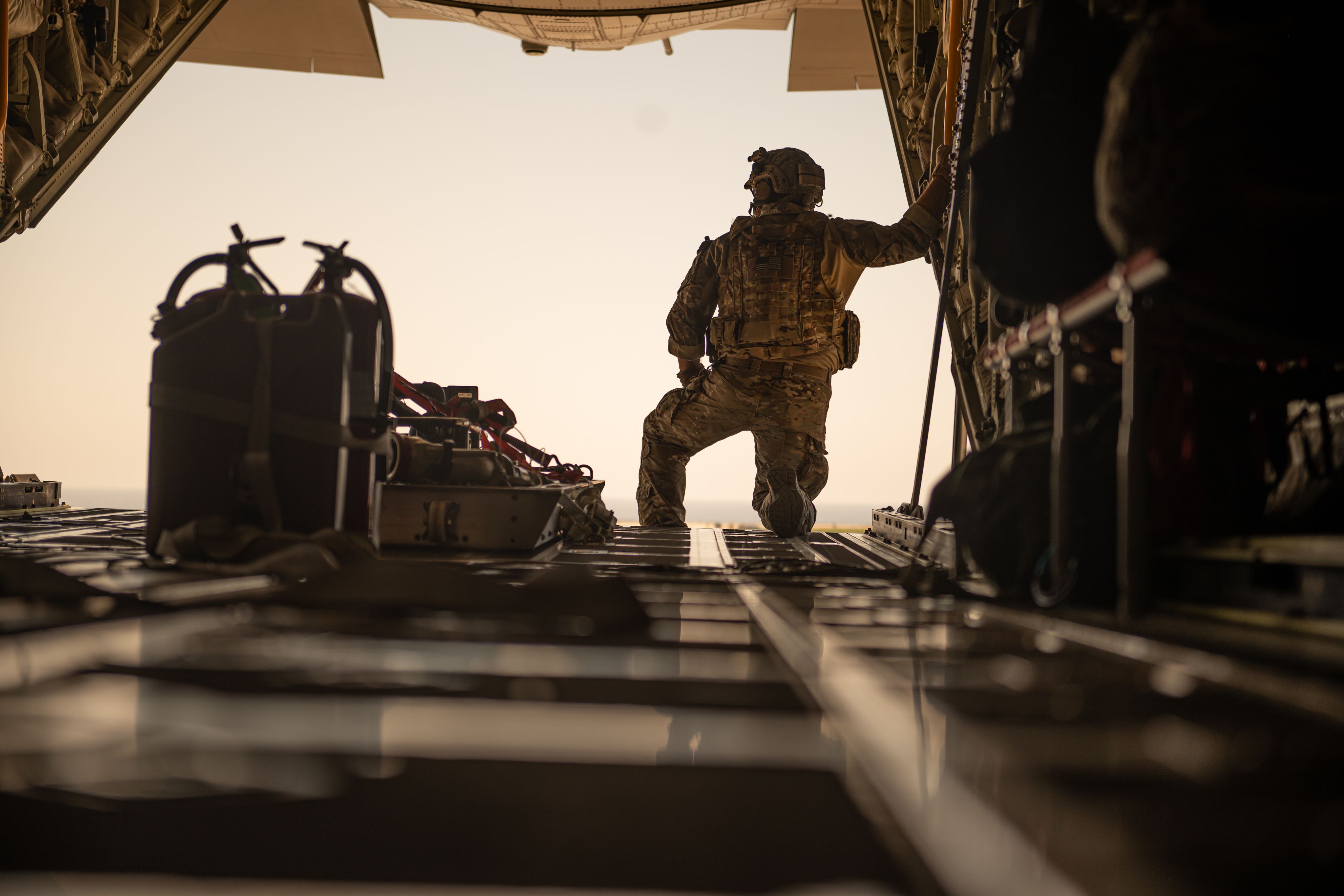 Airmen looks out of the back of aircraft