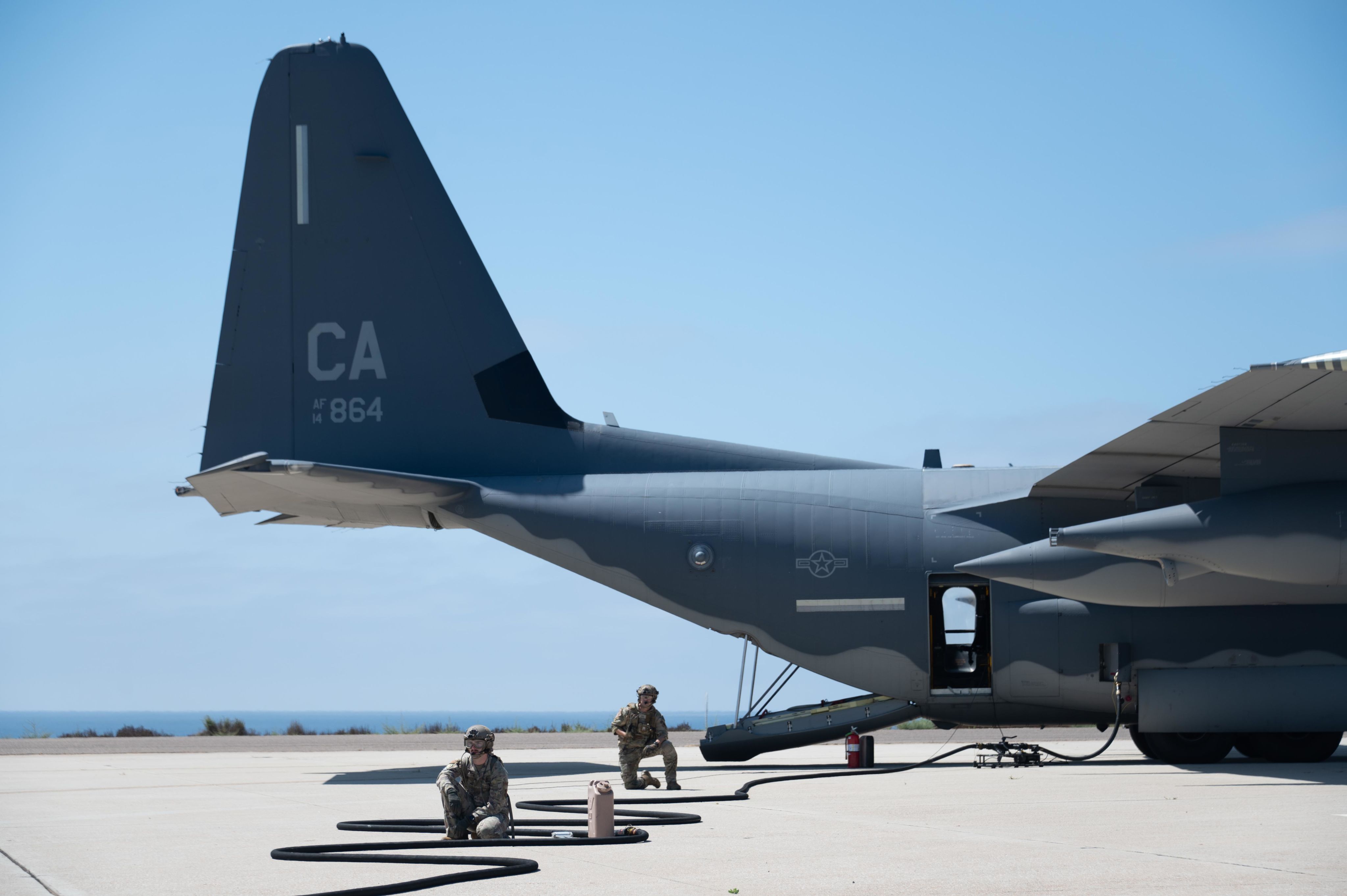 Airmen sit on flightline near aircraft