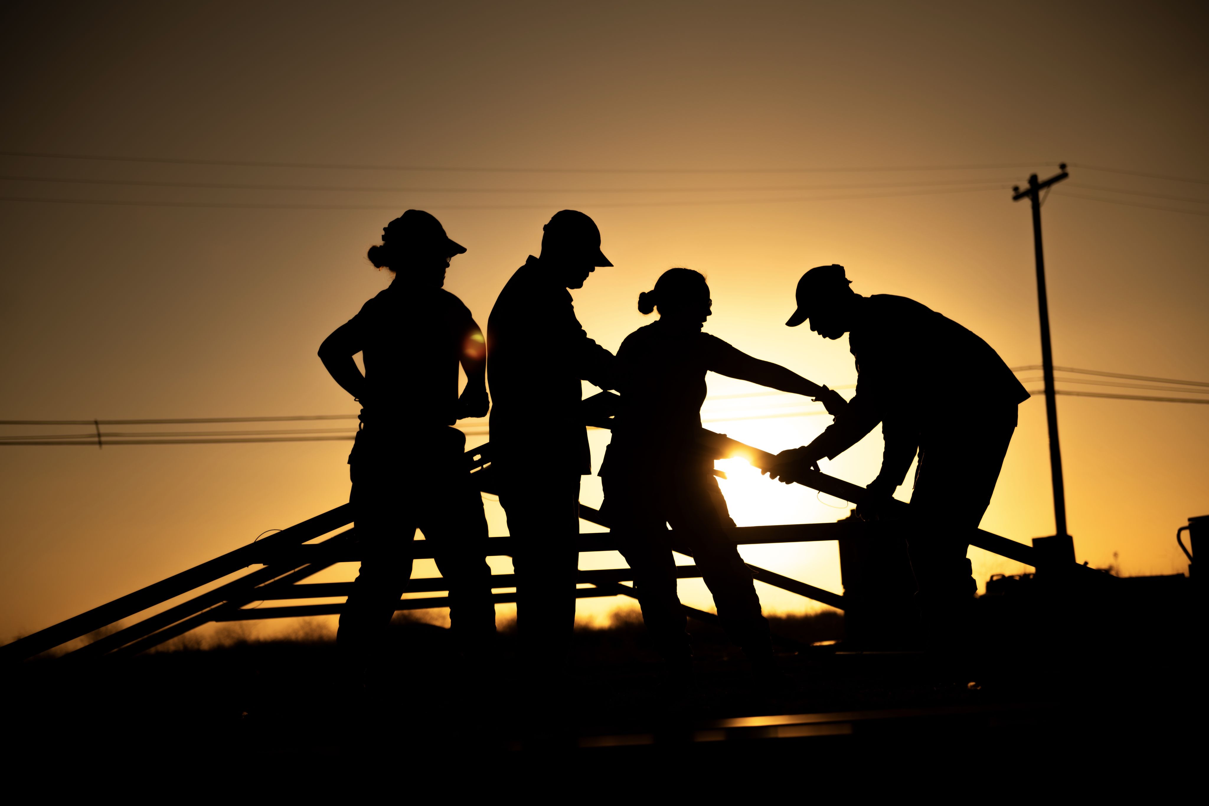 Airmen build structure during sunset
