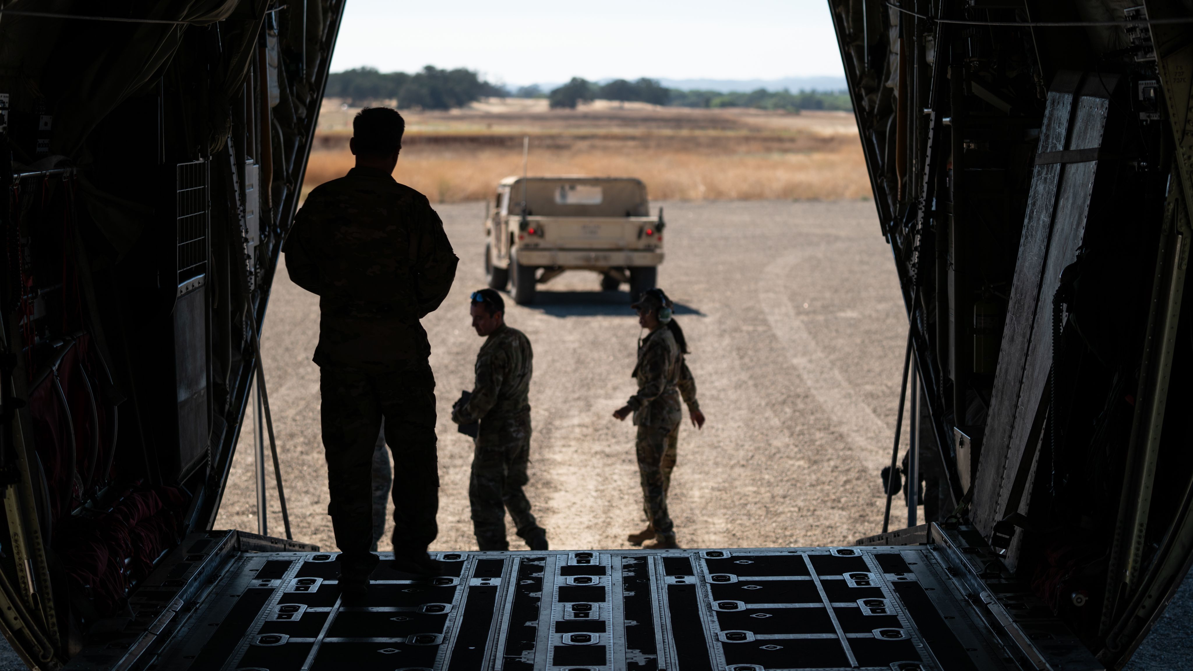 Airmen load a Humvee onto a C-130