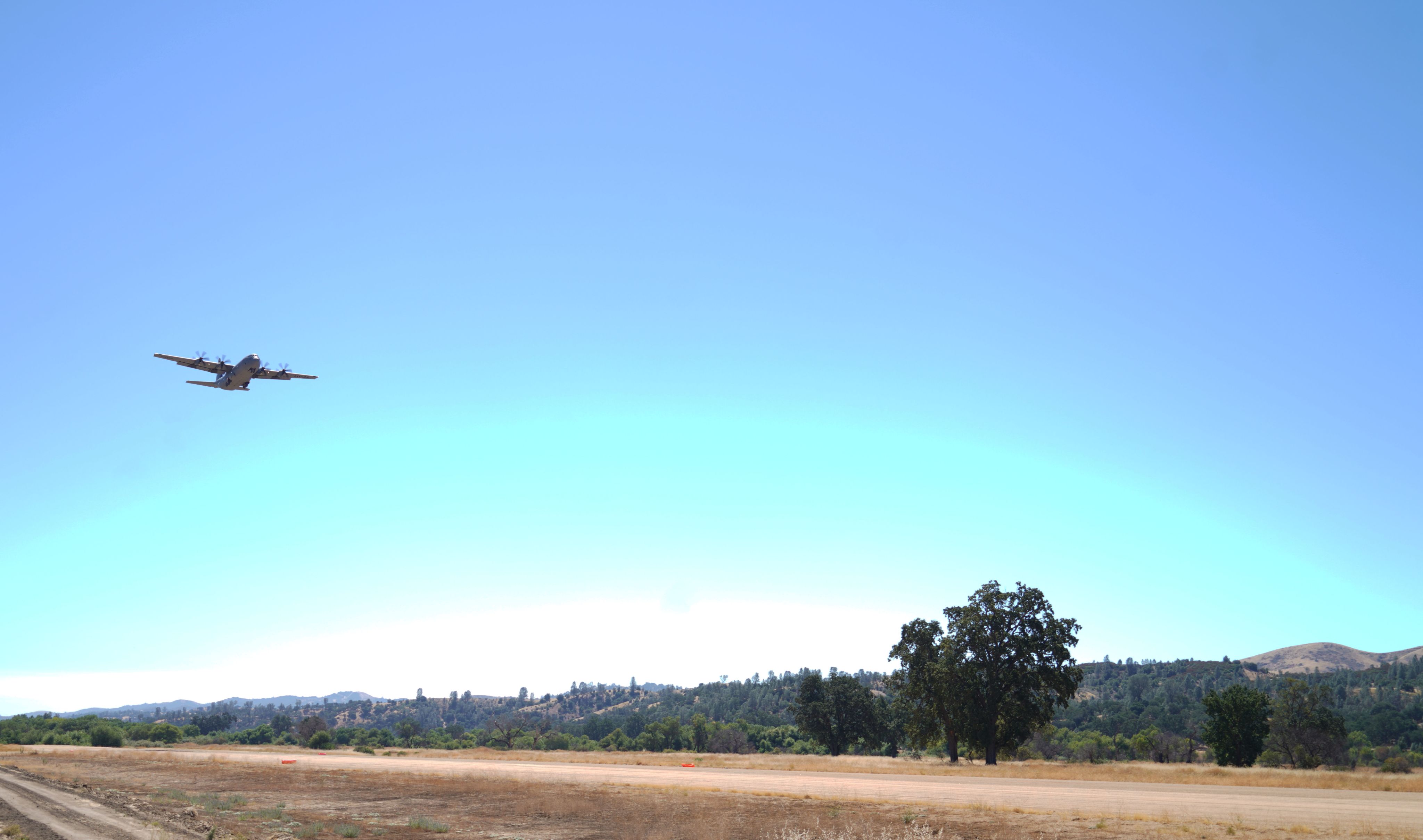 C-130 lands on dirt runway