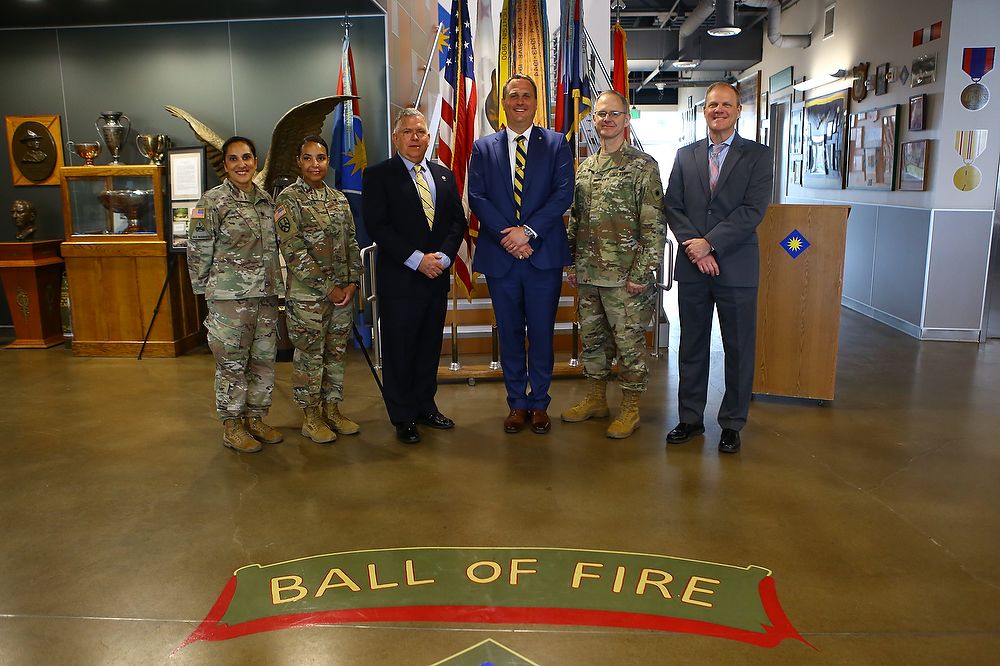 Group photo of service members and civilians.